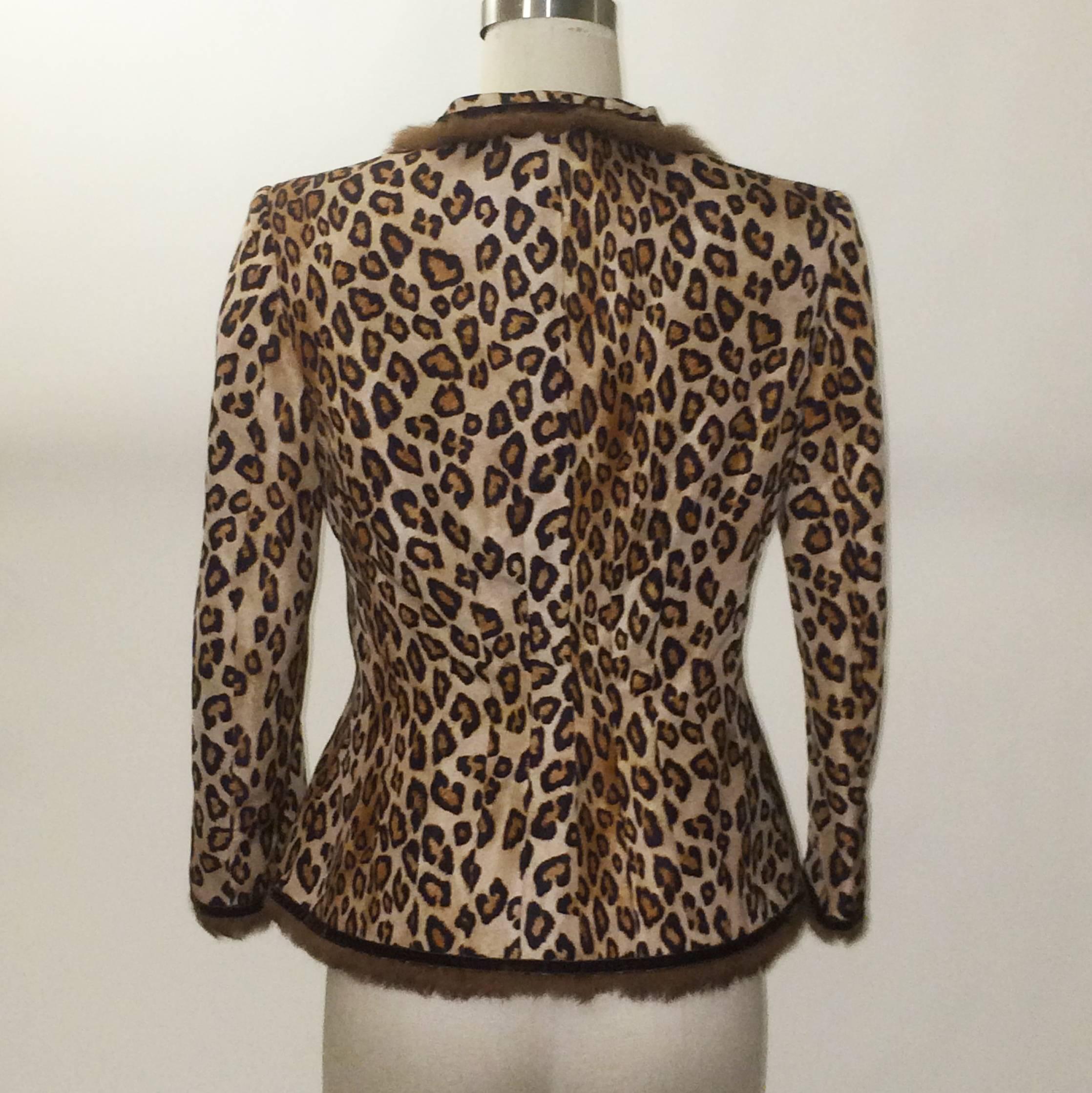 Alexander McQueen leopard print jacket from the 2005 Hitchcock inspired collection 'The Man Who Knew Too Much.' Concealed cloth covered snaps and hooks at front.

100% silk.
Trimmed in 100% rabbit.
Fully lined in 74% acetate 26% silk.

Made in