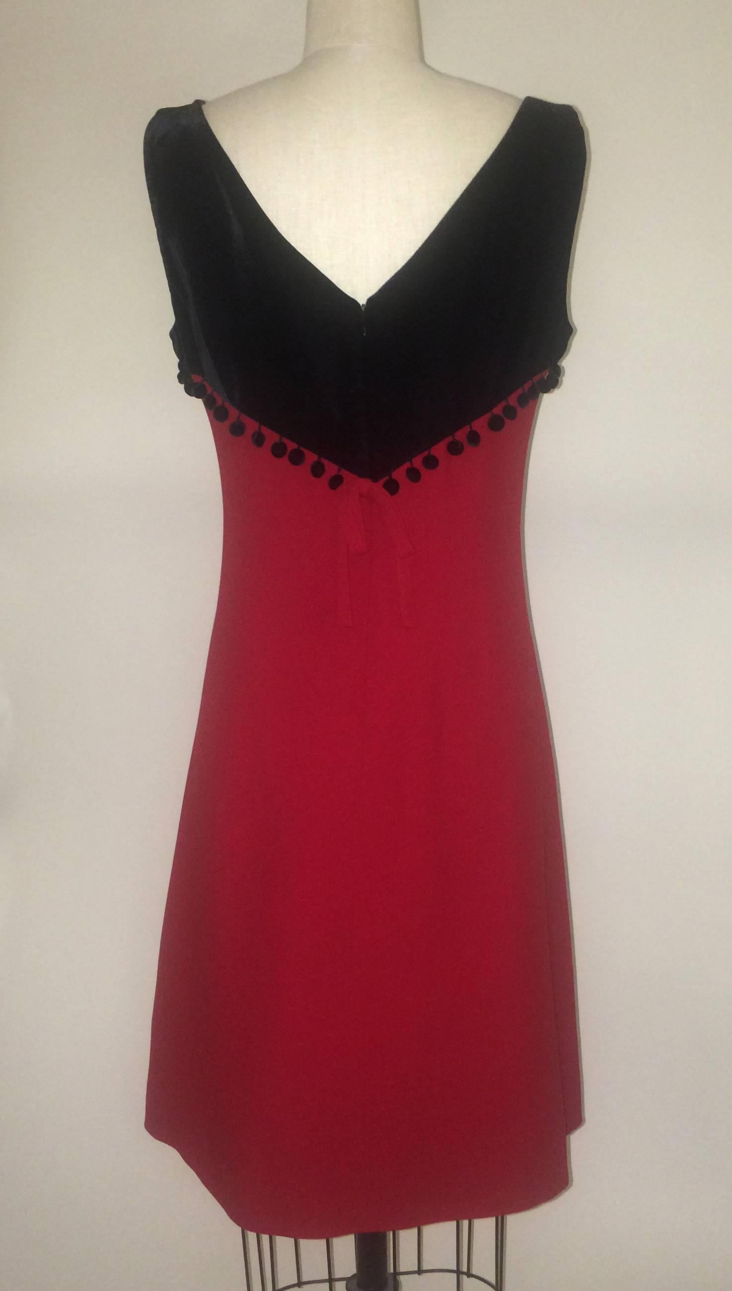 Moschino Cheap & Chic vintage 1990s red dress with black velvet top featuring pom pom trim from Bergdorf Goodman. Small red bow at back.Back zip and hook and eye.

Skirt: 52% rayon, 48% acetate.
Bodice: 59% rayon, 41% cotton.
Fully lined in 60%