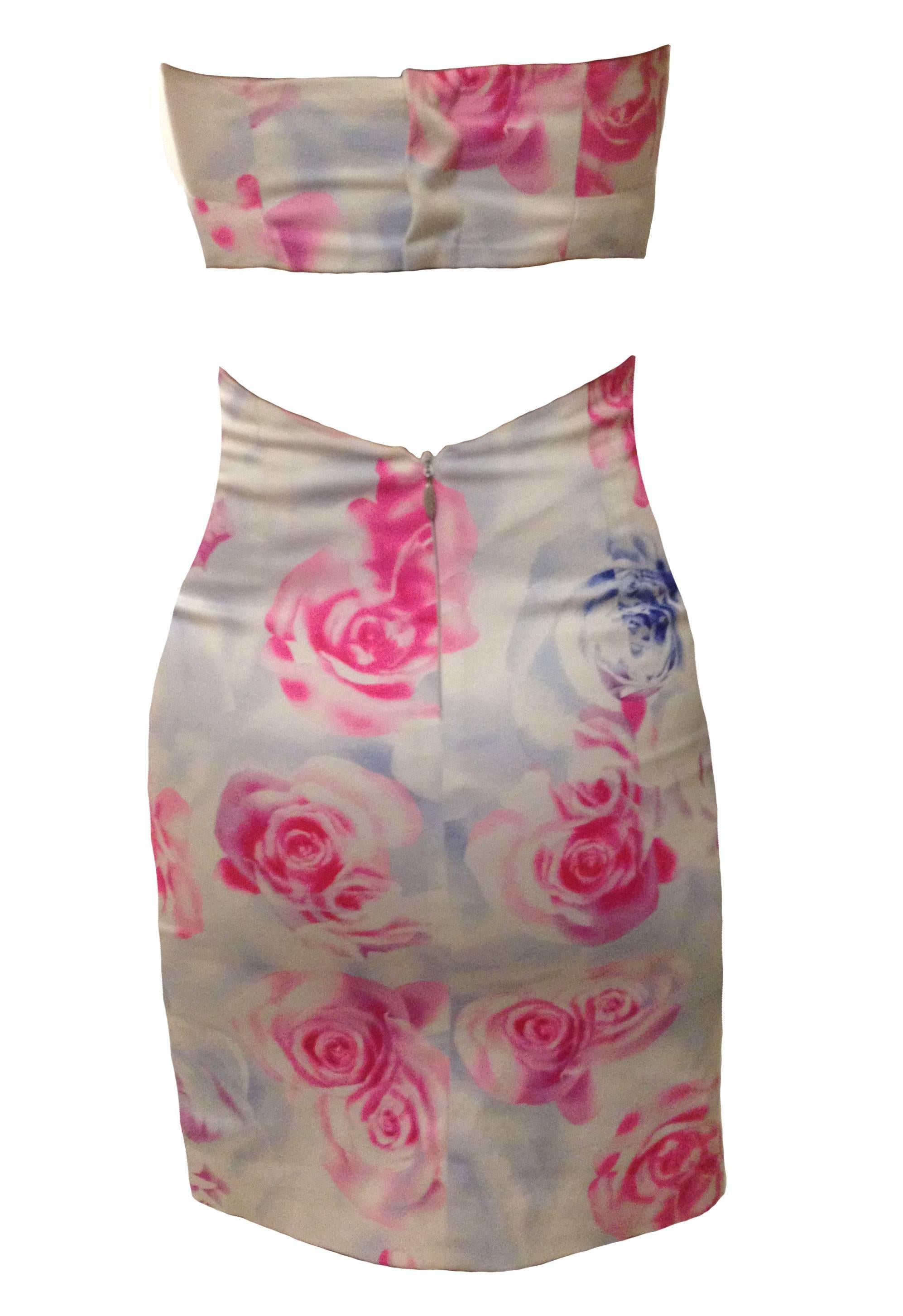 Versus by Versace pink and blue rose print body con strapless dress with cut out back detailing. Zips at back bottom, three snaps at back top. Signed 'Versus' at back zip pull. 

94% cotton, 6% spandex.
Fully lined in 55% viscose, 45%