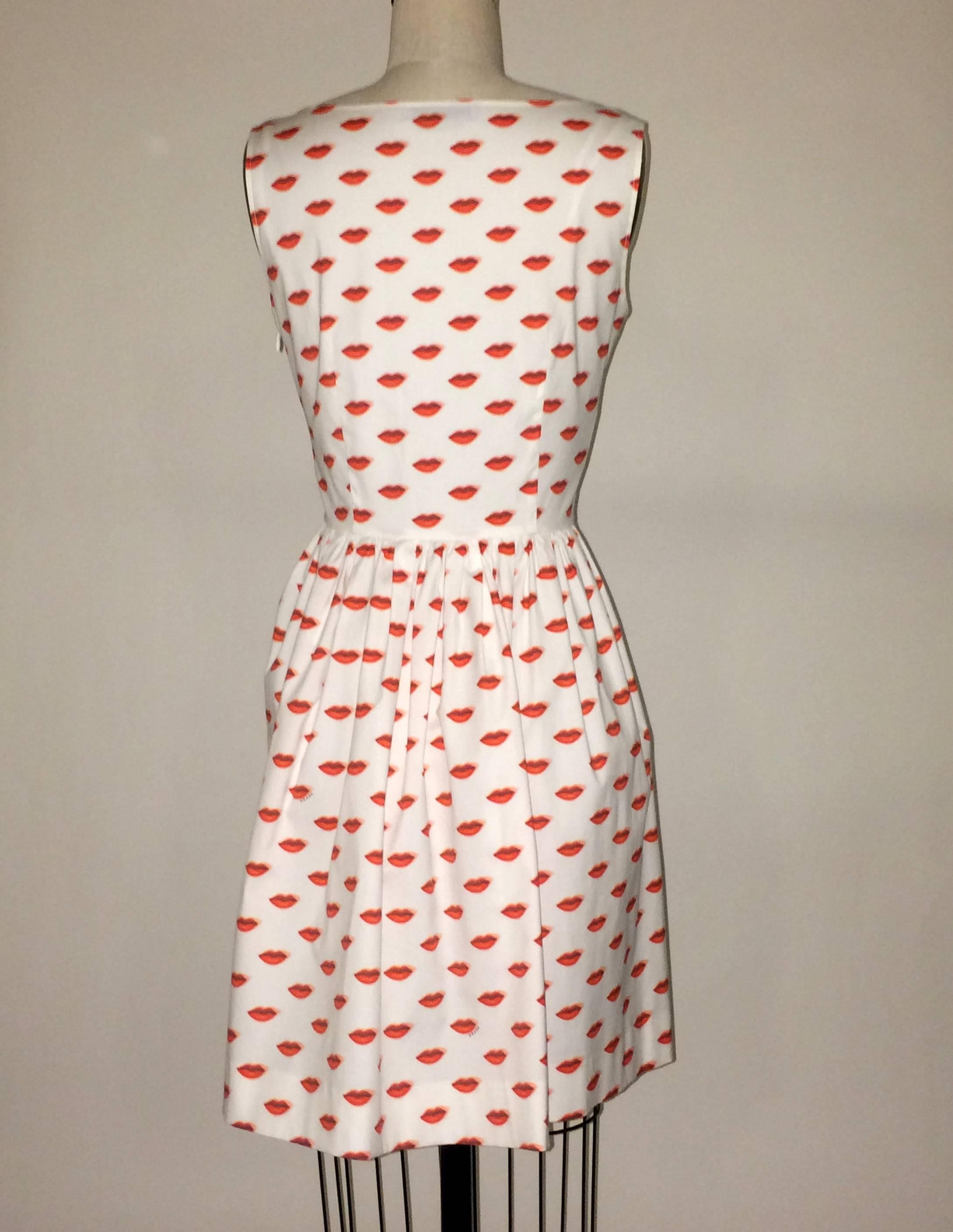 Prada white dress with surrealist red lip print and Prada signature sprinkled throughout. Four working buttons up front bodice. Side zip and hook and eye.

96% cotton, 4% other.

Made in Romania.

Size IT 42, approximate US 6.
Bust