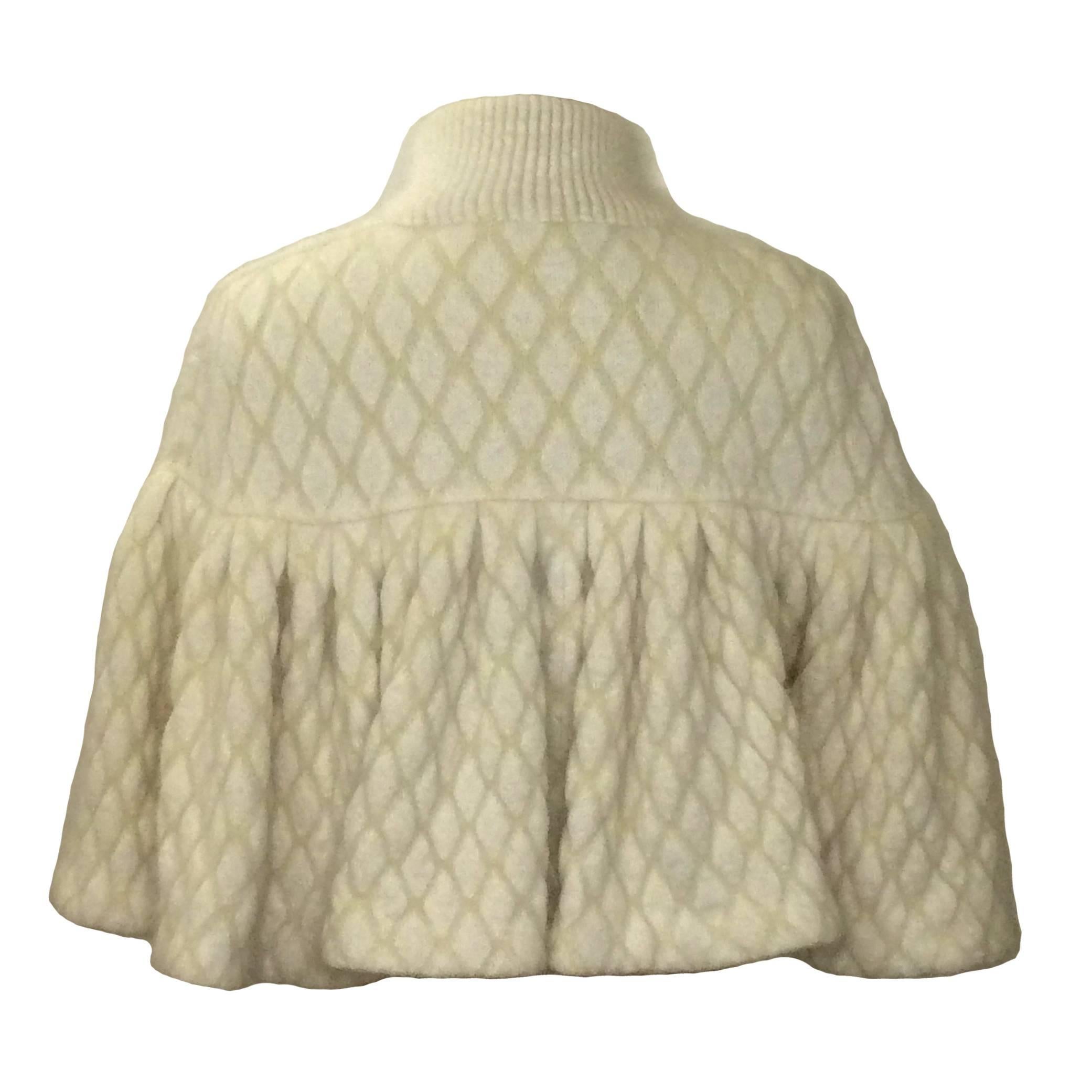Alexander McQueen Fall/Winter 2013 cream capelet in a diamond-knit jacquard. Super soft & fuzzy blend of 56% angora, 25% polyamide, and 19% viscose.

Fastens closed at front with hidden snaps from neck to bottom.

Size Small. 
Measures approximately