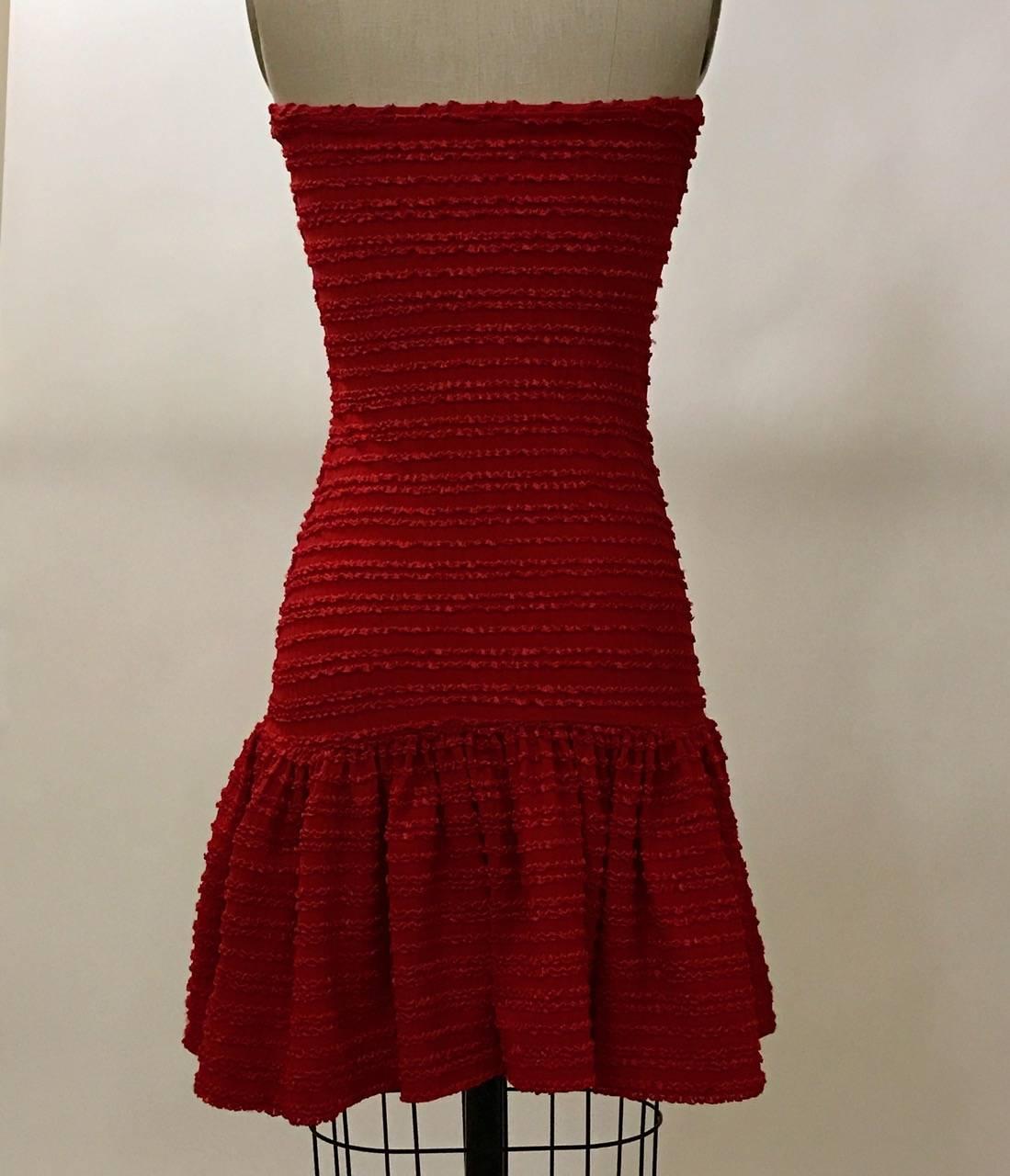 Patrick Kelly vintage 1986 lipstick red strapless dress in one of Kelly's super-sexy signature tube designs. Awesome texture. Sweetheart neckline with gathering at bust.

95% polyamide, 5% elastane.

Made in France.

Size Medium, best fits