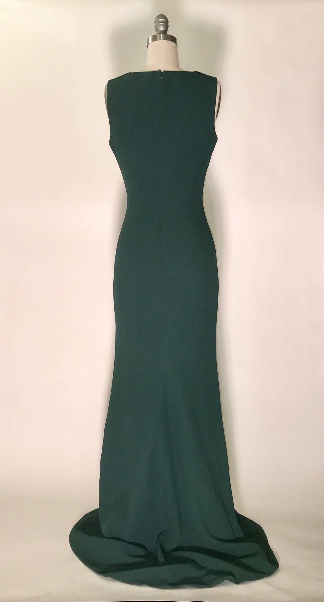 Alexander McQueen 2012 deep forest green dress in a slightly crinkle textured silk crepe with lace insert at bust. Very slight train (back is about 5" longer than front.) Sleeveless, back zip and hook and eye. 

Fabric 1: 100% silk.
Fabric