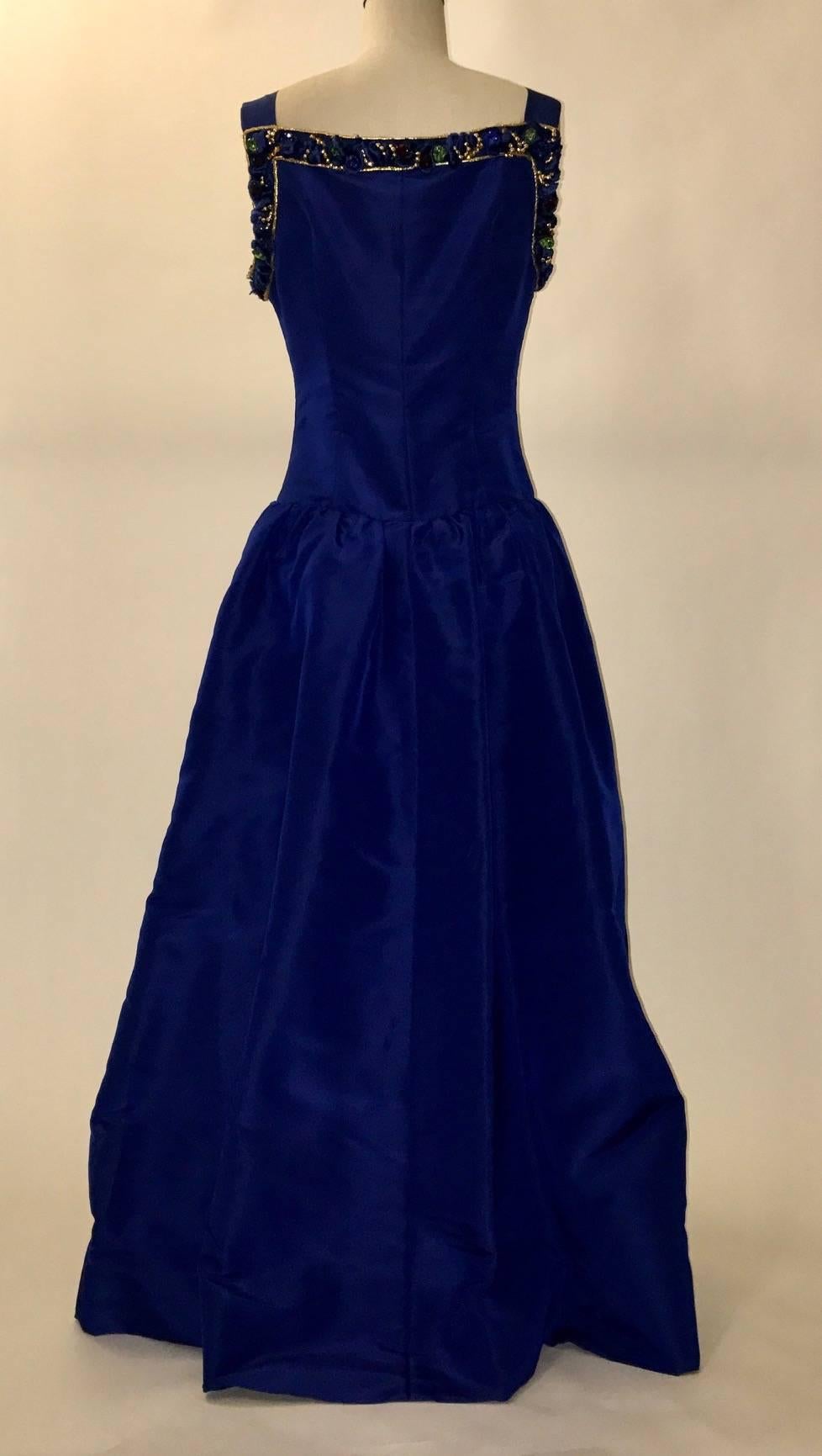 Stunning Givenchy Couture vintage (1980's?) cobalt blue evening gown with gold trim and beaded embellishment at neck. Side zip, fully lined, side slip pockets.

No content label, seems like mid-weight silk faille.

Made in France.

Labelled