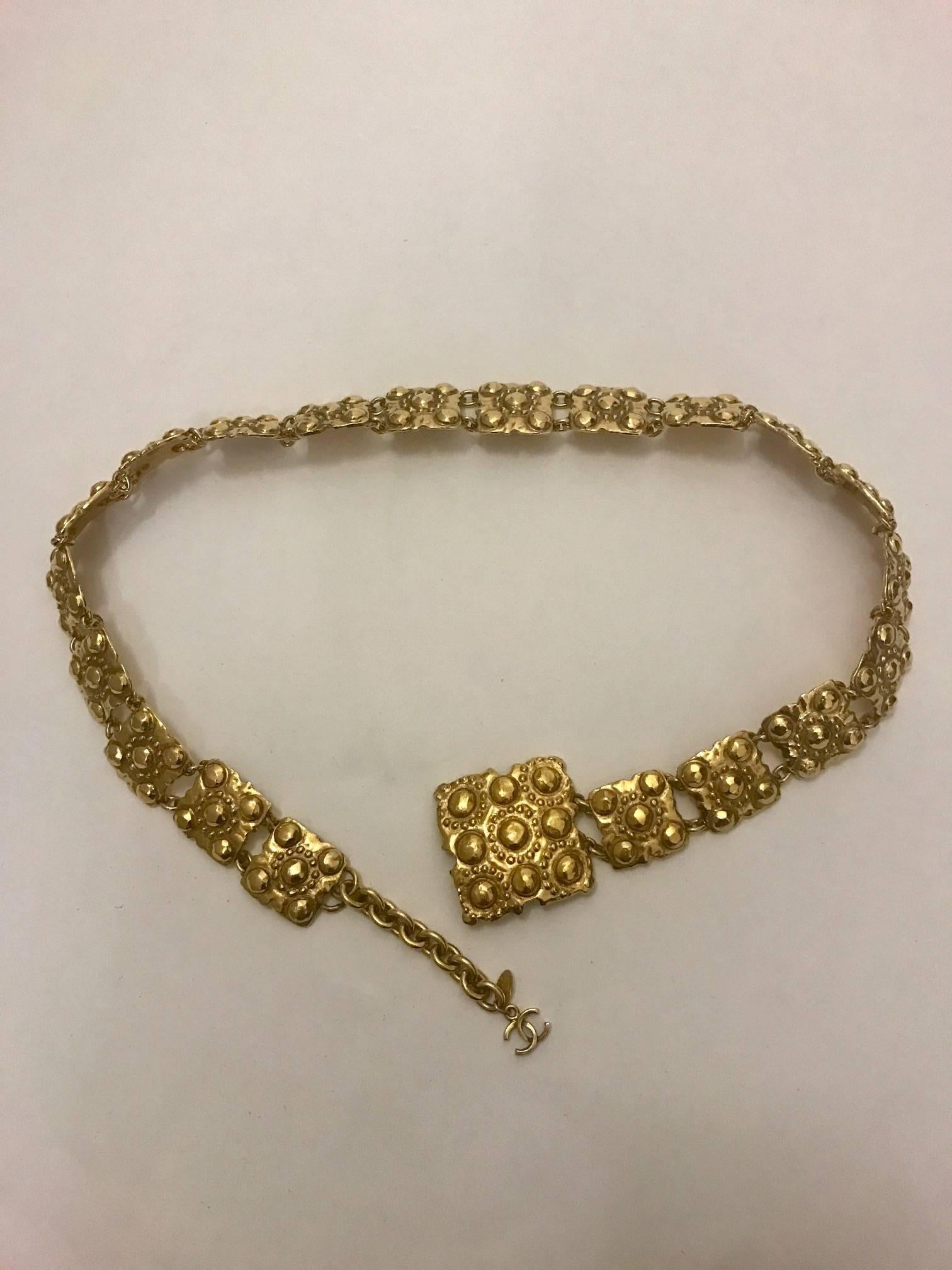 Chanel vintage gold tone belt from collection 23 (1986, first year of jewelry designer Victoire de Castellane.) Gold chain links connect square medallions with raised round detailing. Hanging CC logo at front.

Stamped 'Chanel, 2 CC 3, Made in