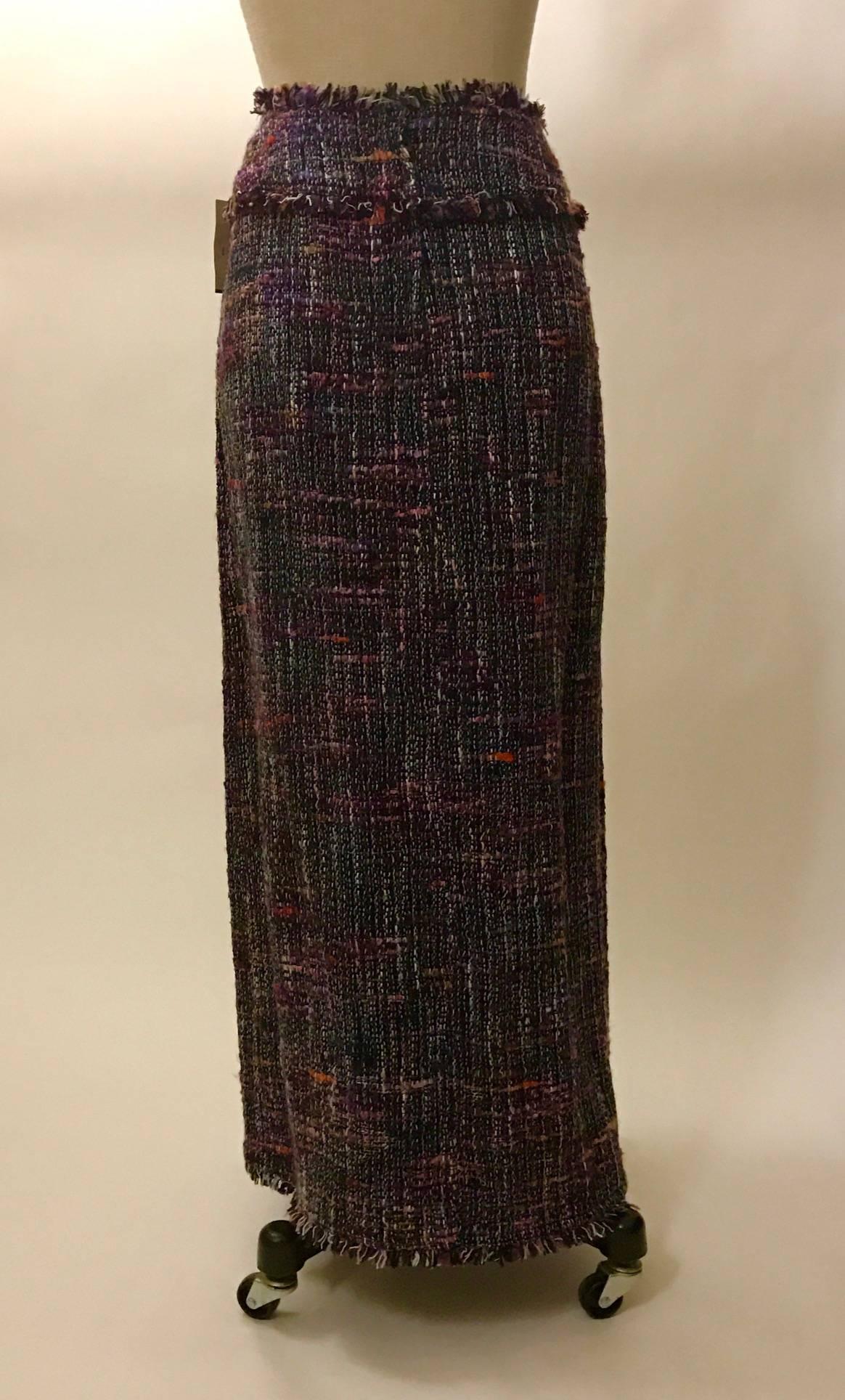 New with tags Chanel 98 P maxi length tweed skirt from Bergdorf Goodman. Banded waist with wrap style skirt. Fringed edge at waist, down front of skirt where top layer overlaps, and at hem. 

64% acrylic, 20% rayon, 12% silk, 4% nylon. 
Fully