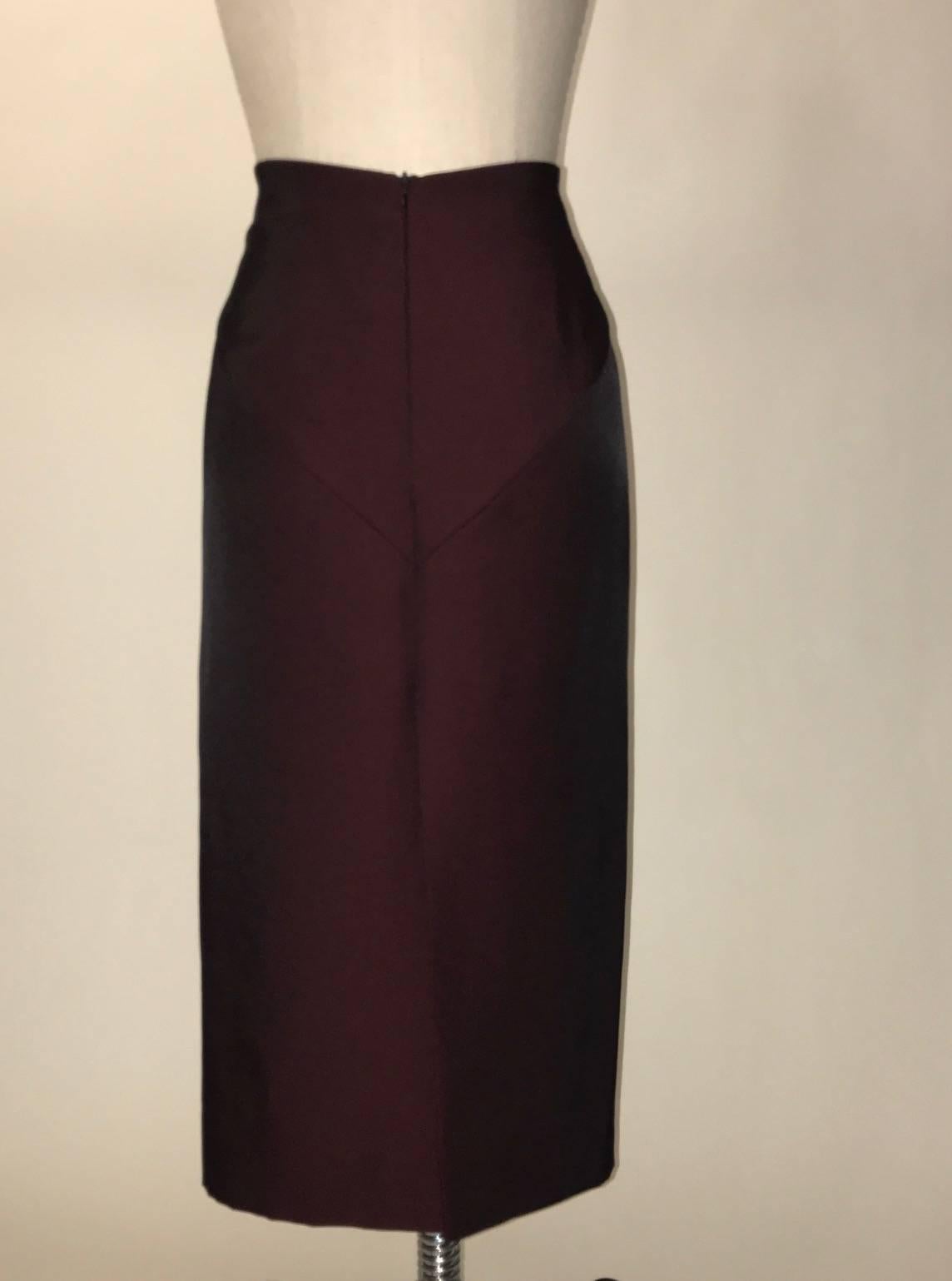 Alexander McQueen midi length pencil skirt in an interwoven maroon and black textile. Yoke detail at front and back waist. Slit at center back. Zipper closure at center back. 

Fabric content unknown, feels like a synthetic blend.
Fully lined in