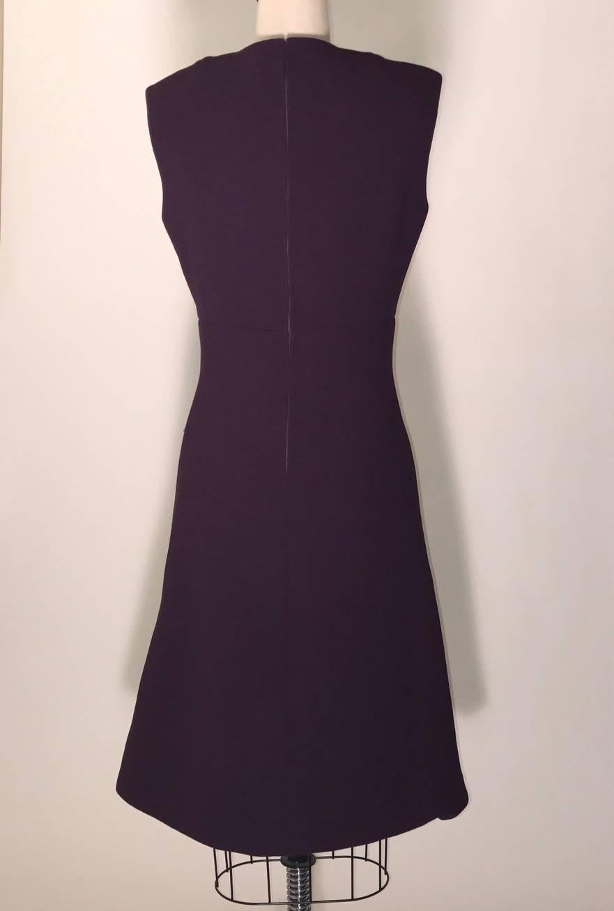 Pauline Trigere purple wool crepe A-line shift dress with open slit detail at chest. L shaped seams at bodice. Back zip and hook and eye.

Fully lined in silky fabric. 

No size tag, see measurements.
Bust 36