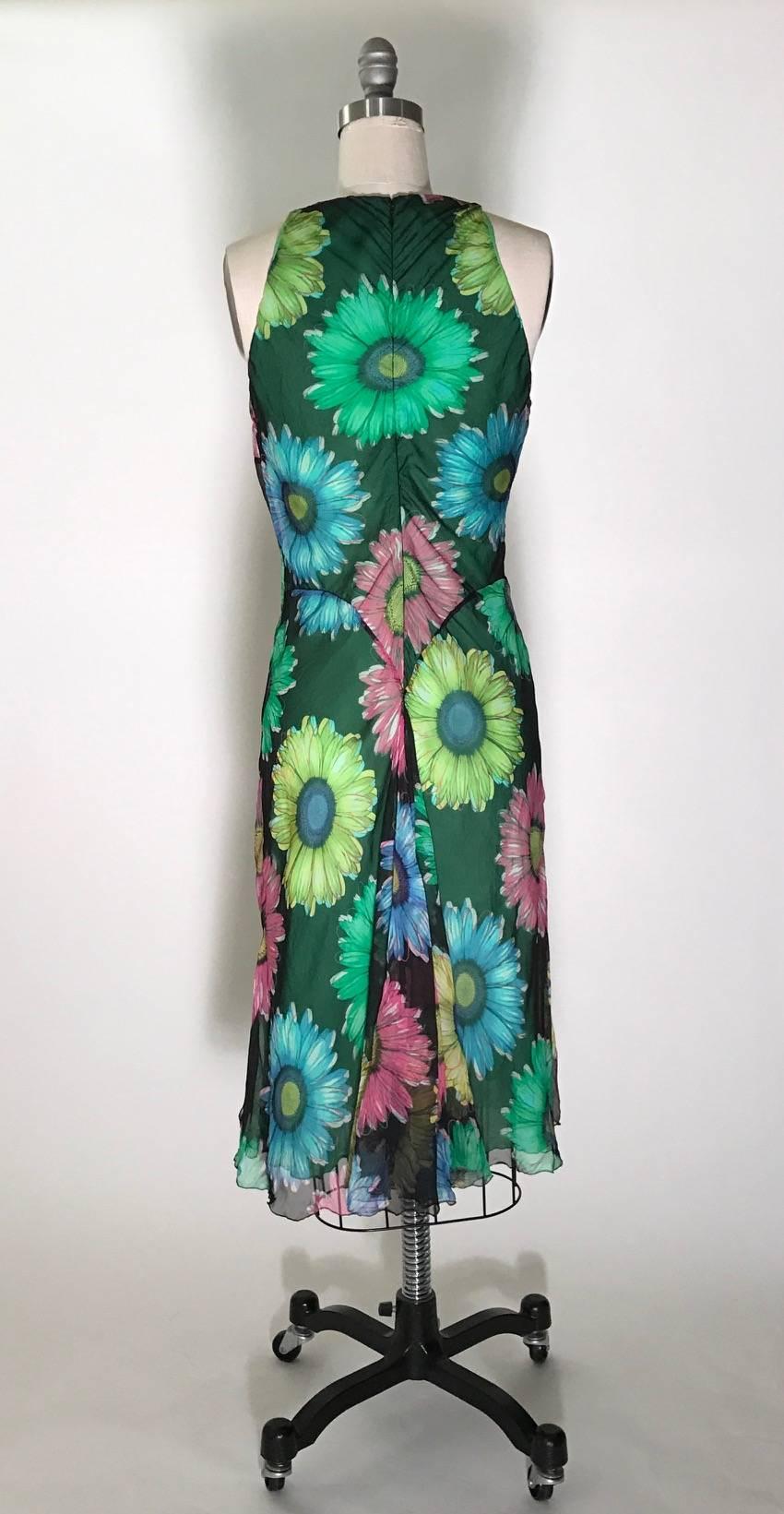 Gianni Versace Couture vintage 1990s sleeveless dress with a black and multicolor floral print chiffon layer atop another layer of semi-sheer green. Fishtail detailing at back and slits at sides of top layer. Back zip and hook and eye.

Made in