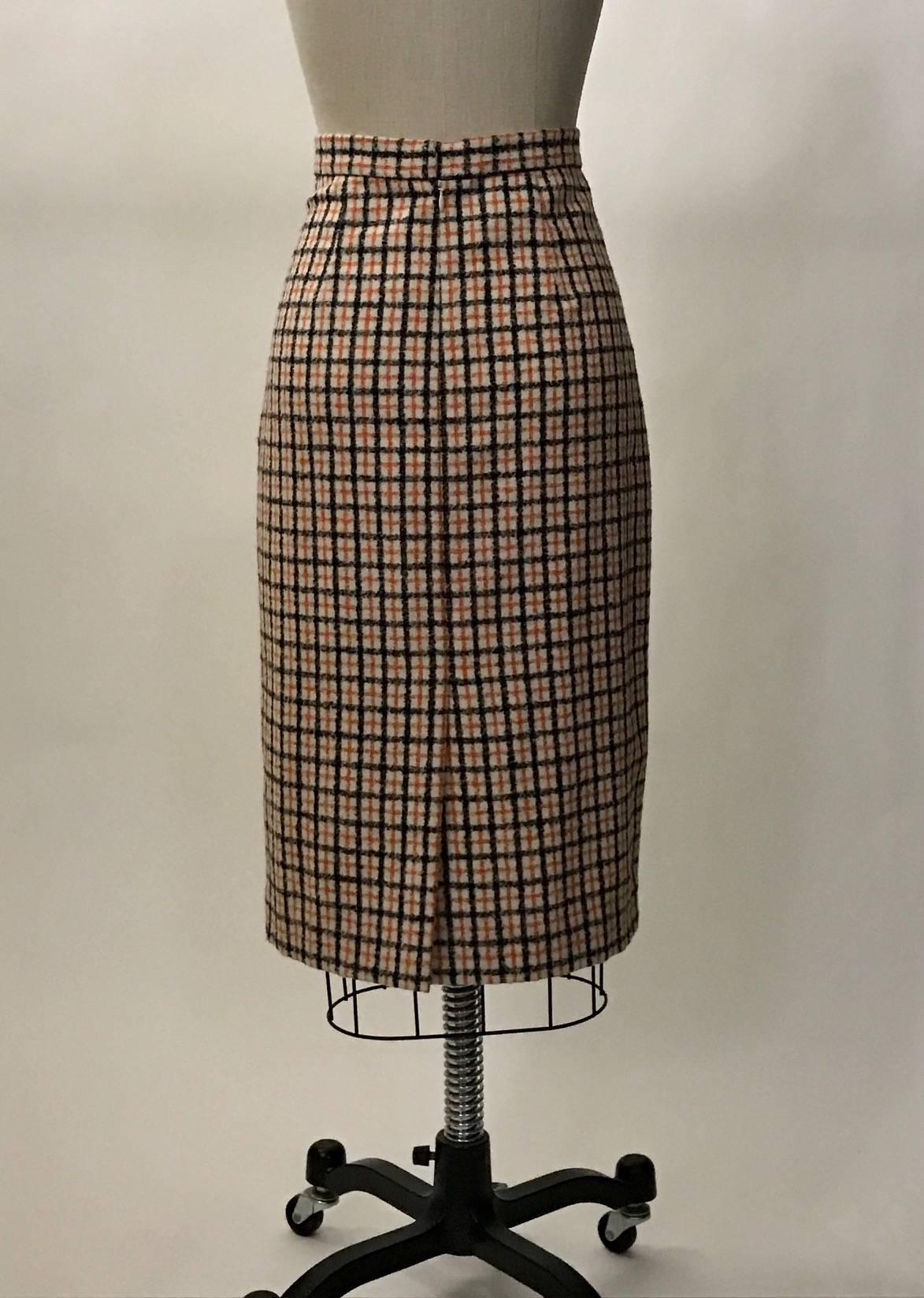 Carolina Herrera orange, white, and navy plaid wool pencil skirt. Slit at center back. Back zip, hook, and snap. 

100% wool.
Fully lined in what feels like silk. 

Made in USA.

Size 4.
Waist 27".
Hip 36".
Length