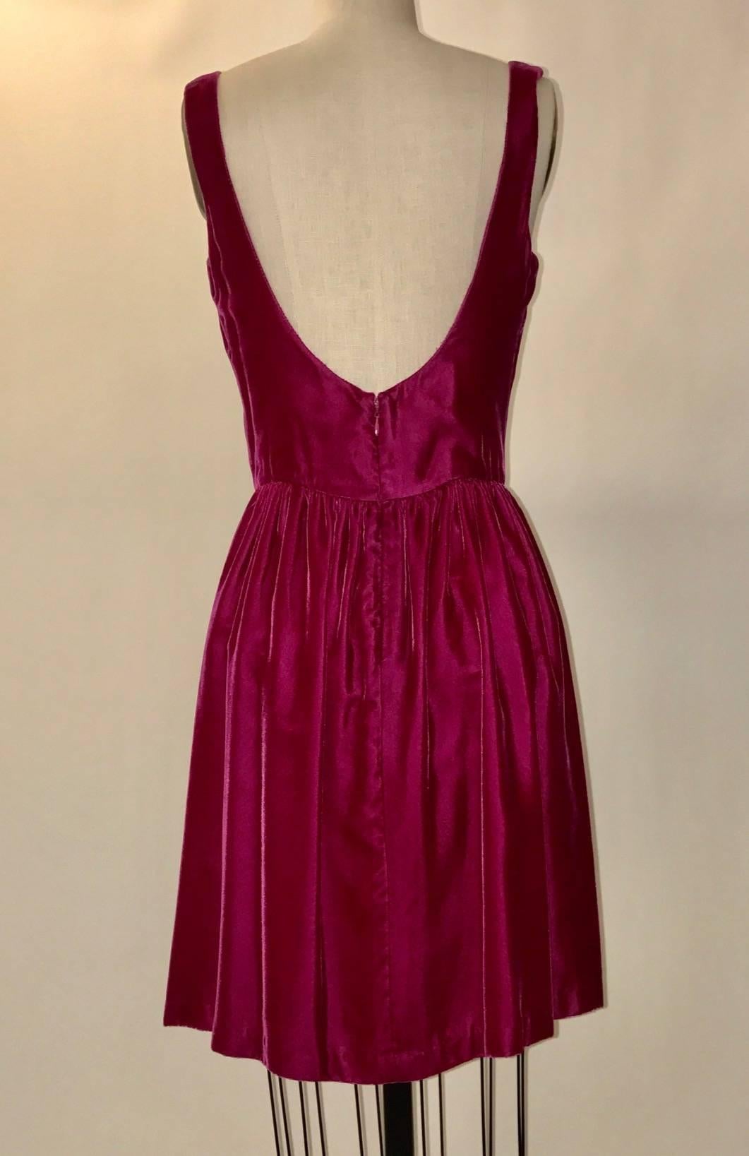 Raspberry velvet vintage 1980's sleeveless dress with flared skirt from Stephen Sprouse's 'Sprouse' line. Cut low at back. Back zip and hook and eye closure.

100% rayon.
Fully lined.

Made in USA.

Labeled size 8, fits more like modern 4/6. See