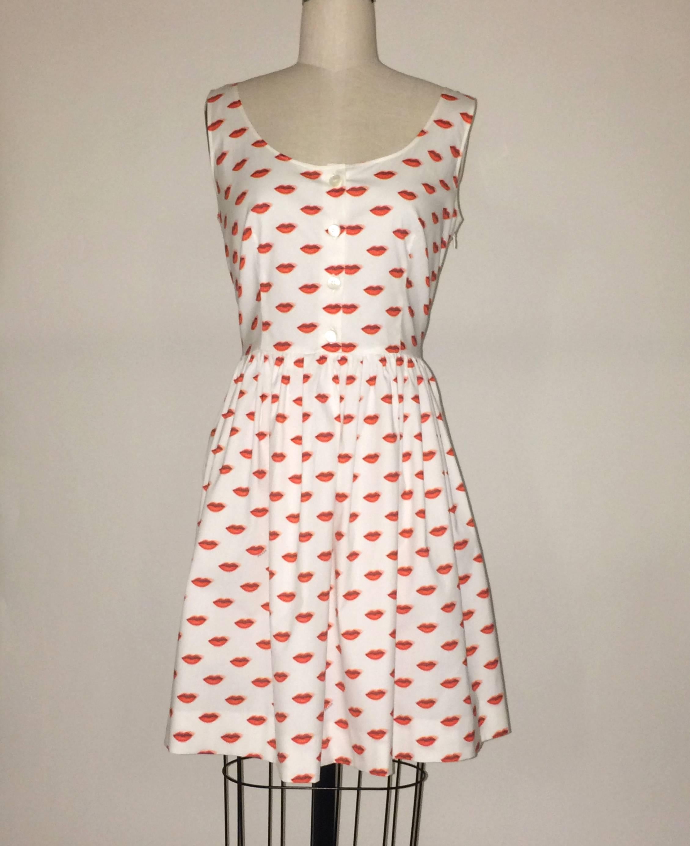 Prada white dress with surrealist red lip print and Prada signature sprinkled throughout. Four working buttons up front bodice. Side zip and hook and eye.

96% cotton, 4% other.

Made in Romania.

Size IT 42, approximate US 6.
Bust 34