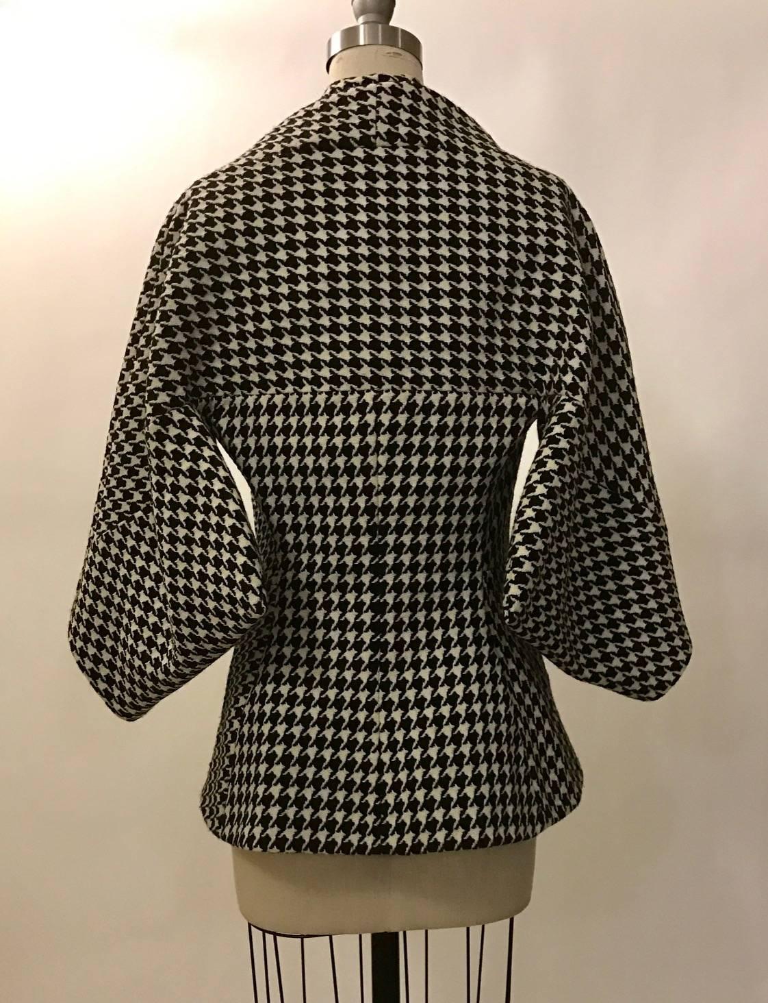 Alexander McQueen black and white dogtooth wool jacket from the 2009 Horn of Plenty collection. Jacket features a kimono like sleeve and pleat detail at shoulder. Fastens with three concealed buttons at front. 

100% virgin fleece wool.
Fully lined