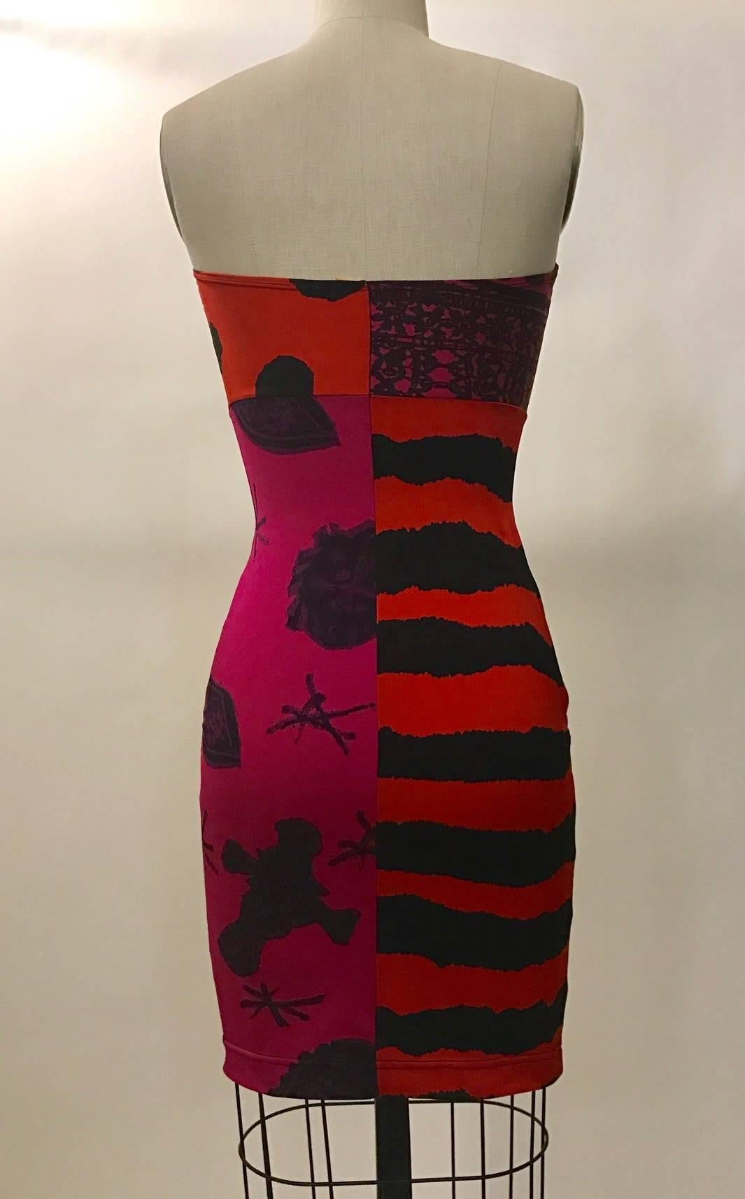 Christian Lacroix Pret-a-Porter 1990s super stretchy bodycon strapless dress in quartered red and pink fabric with black graffiti-like polka dots, stripes, and tribal print. Pull on, unlined.

80% polyamide, 20% lycra. (Great for a pool or swim