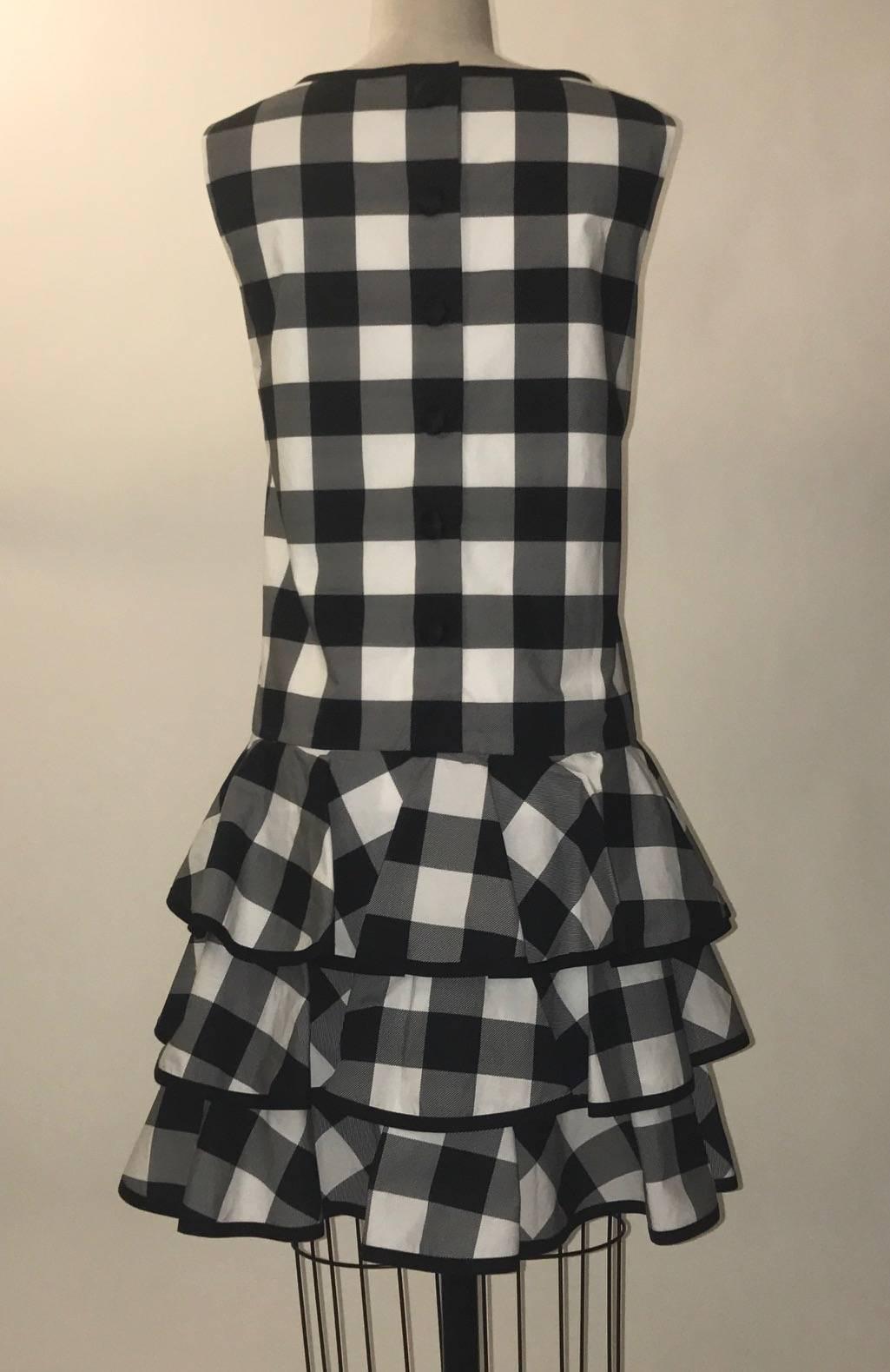 Dolce & Gabbana black and white checked sleeveless sundress with three tiers of ruffles at skirt. Black cloth covered snaps at back.

100% cotton.
Lined at top in 100% cotton.

Made in Italy.

IT 44, US 8. See measurements.
Bust 38