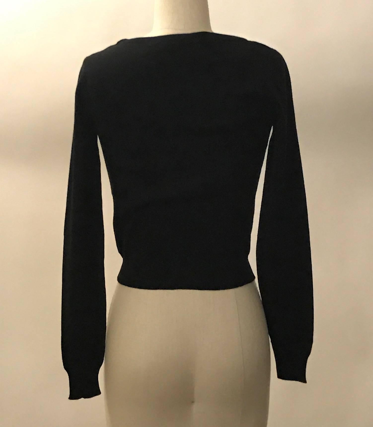 Recent Moschino Couture by Jeremy Scott black and white sweater with 'Dry Clean Only' in intarsia knit print at front. Crew neck, long sleeves, shorter, fitted style.

100% virgin wool. 

Made in Italy.

Size IT 38, best fits XS. Stretchy,