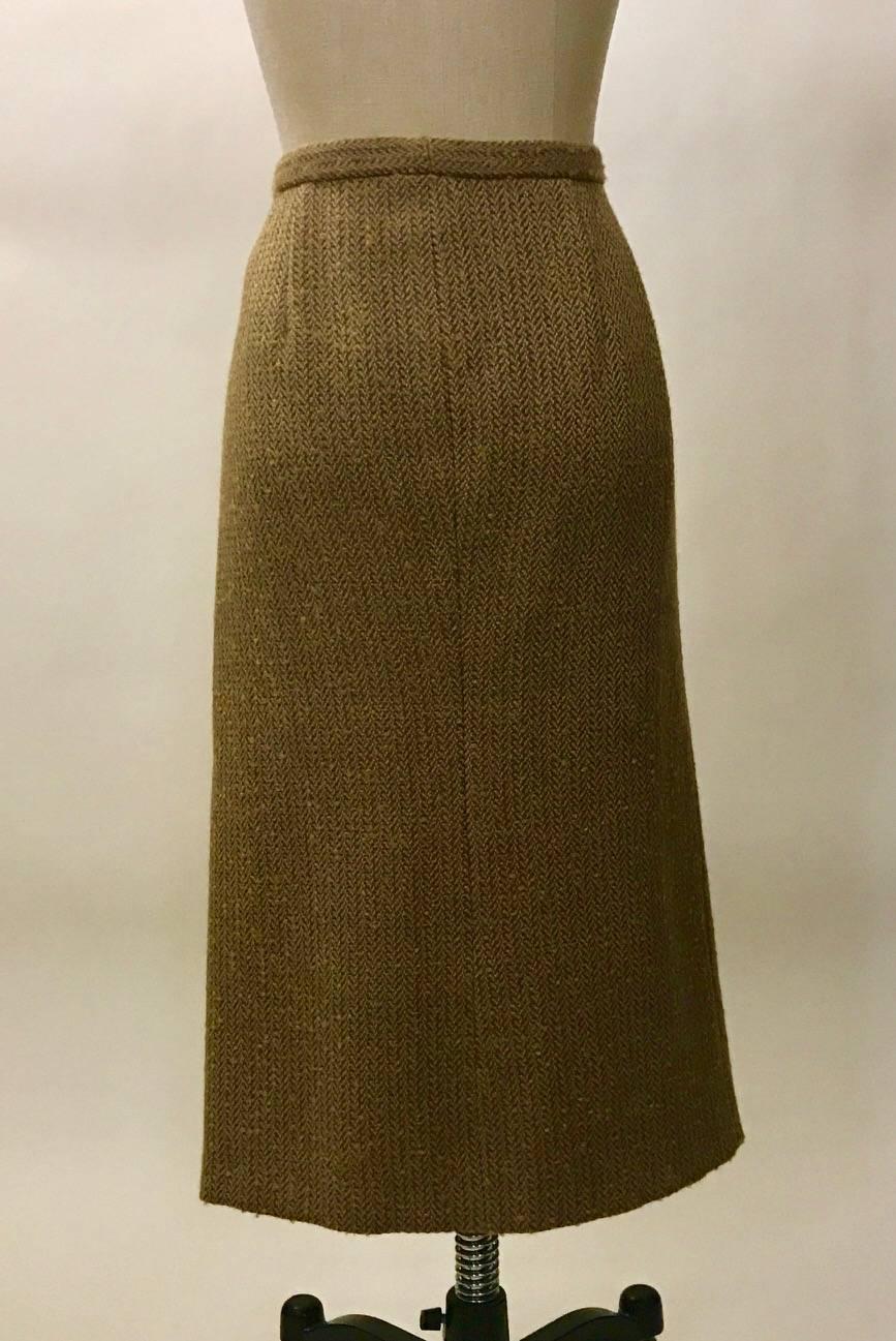Alexander McQueen buckle and safety pin accented skirt from the Fall 2005 Hitchcock inspired collection "The Man Who Knew Too Much." Tan and brown twill with a touch of goldenrod/orange.  Fastens in a wrap style with a hidden button at