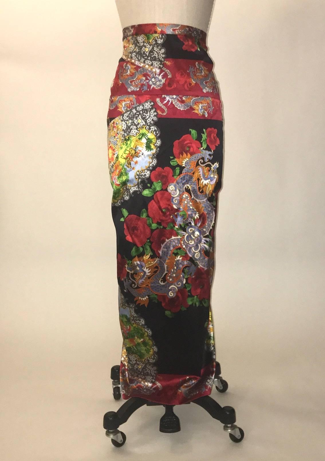 Dolce and Gabbana silk blend skirt features an Asian inspired print featuring dragons, roses and fans depicting countryside scenes. Amazing ruched detailing at back. Closes at back with ten hook and eyes and a snap. Eight inch slit at back center