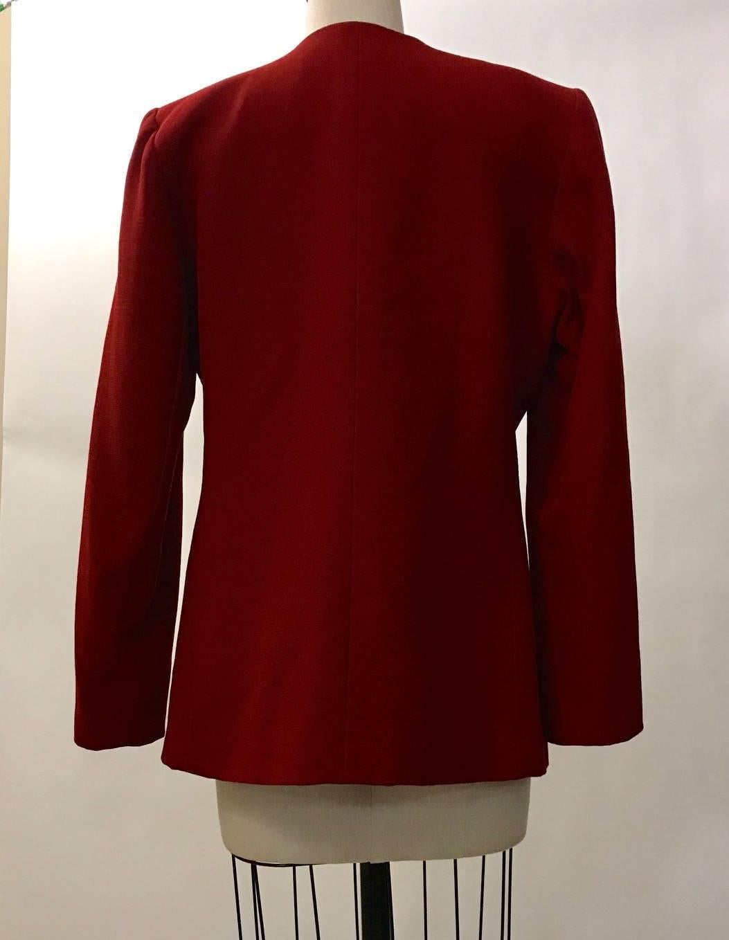 Yves Saint Laurent Encore mid 1990's deep cherry/burgandy red blazer with textured black panels and single frog closure at front. 

No content tag. Possibly a very light wool blend.
Fully lined.

Made in France.

Labelled size FR 38, US 6. See