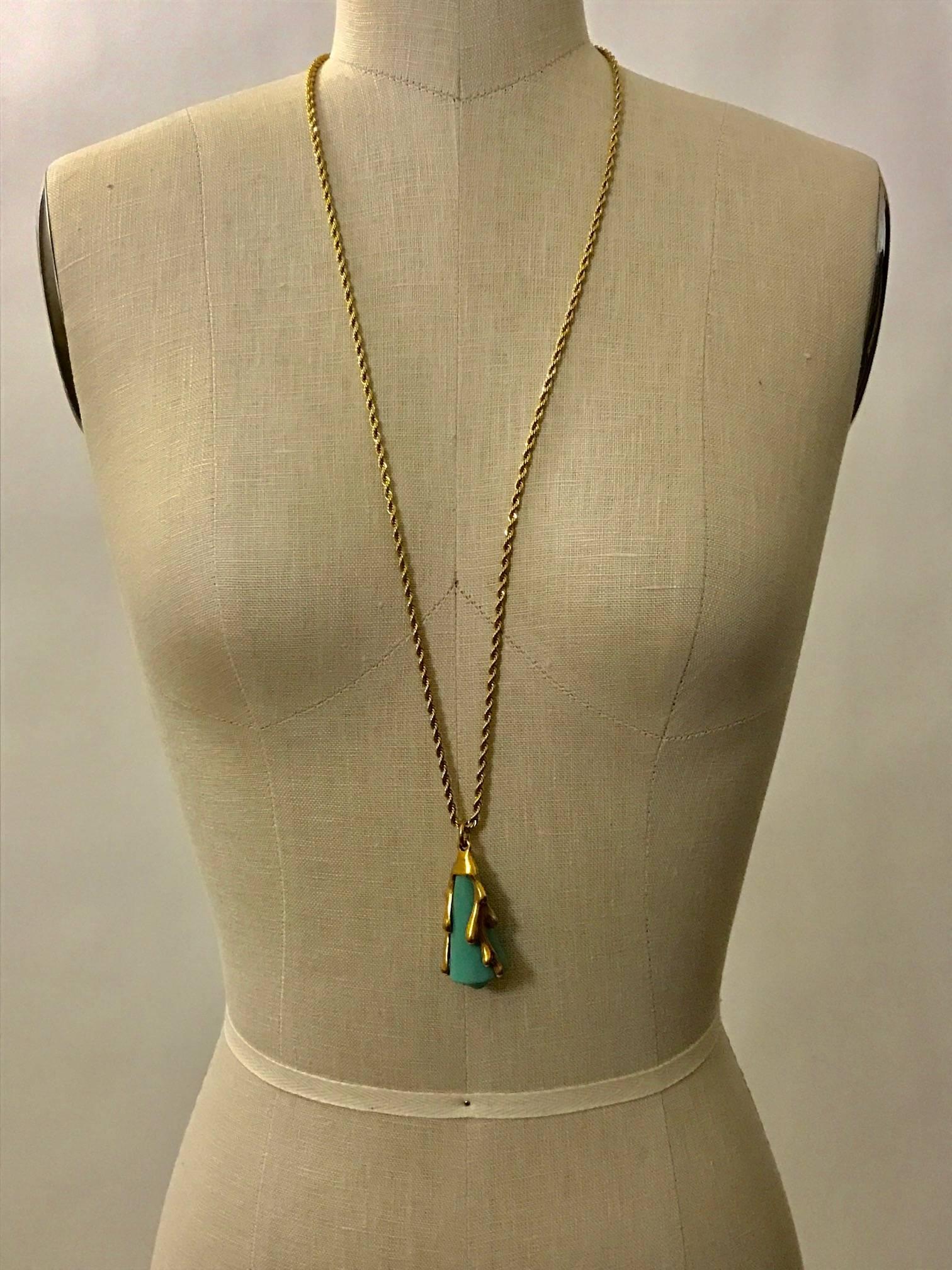 Oscar de la Renta gold tone necklace features coral holding a turquoise shell.

Signed 'Oscar de la Renta' at tag.

Pendant measures approximately 2