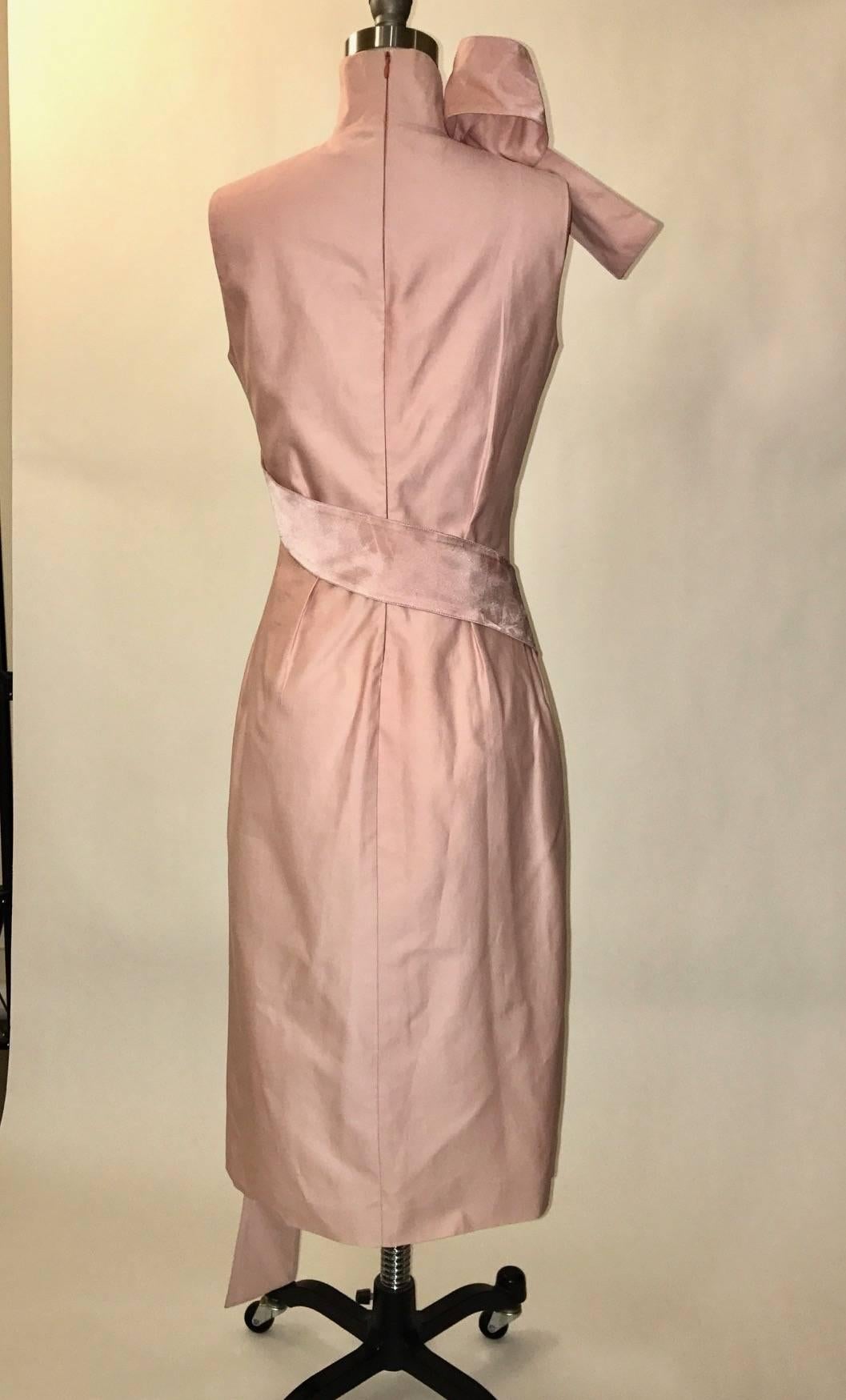 Alexander McQueen pink dress from his acclaimed Spring Summer 2001 Voss collection. High neck, very fitted style with a pink ribbon wrapping around the body and ending in a sculptural loop at neck. Back zip.

73% cotton, 23% silk.
Fully lined in