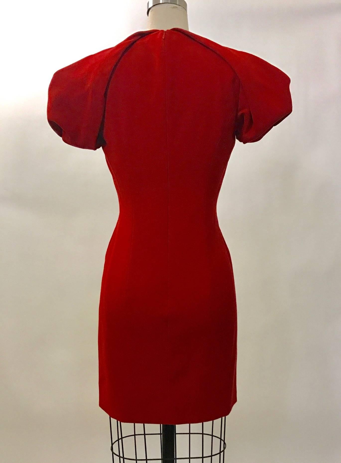 Alexander McQueen light wool crepe fitted v-neck dress in lipstick red with voluminous folded shoulder detail. Back zip and hook and eye. 

100% virgin fleece wool. 
Fully lined in 74% acetate, 26% silk.

Made in Italy.

Size IT 40, approximate US