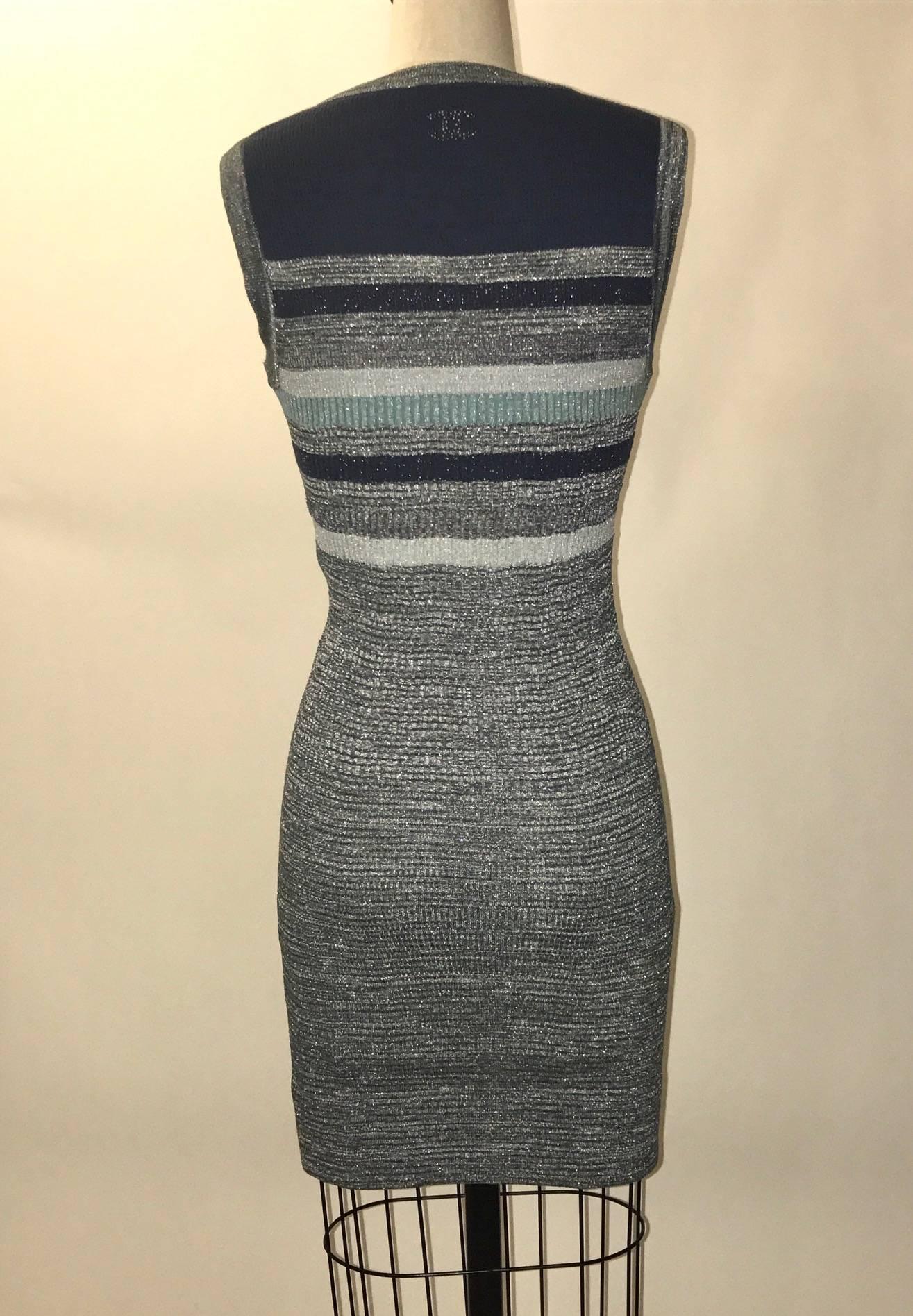 Chanel blue and grey knit sleeveless dress with metallic sparkle detail throughout and CC logo in small round studs at back top.

52% cotton, 26% nylon, 12% rayon, 7% polyester, 3% cashmere.
Unlined.

Made in France.

Size FR 36, approximate US 4.