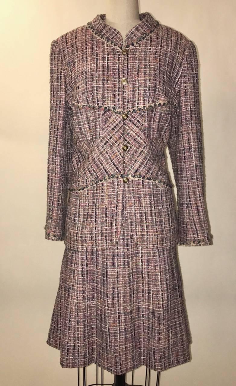Chanel multicolor weave A-Line skirt suit featuring hues of lavender, red, light blue, navy, white, and pink. From the 03A collection by Karl Lagerfeld. Novelty gold lion buttons. Includes optional scarf.

58% cotton, 18% wool, 15% silk, 6% rayon,