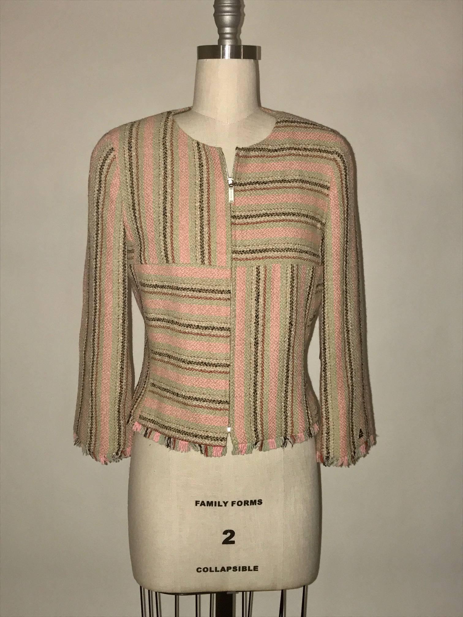 Chanel tweed jacket in muted pink, sage green, natural, and red stripes. Fringed, raw edge trim. Branded 'Chanel' at zipper front and 'Chanel Paris' on triangular charm at cuff. Features signature Chanel chain detailing at bottom of interior