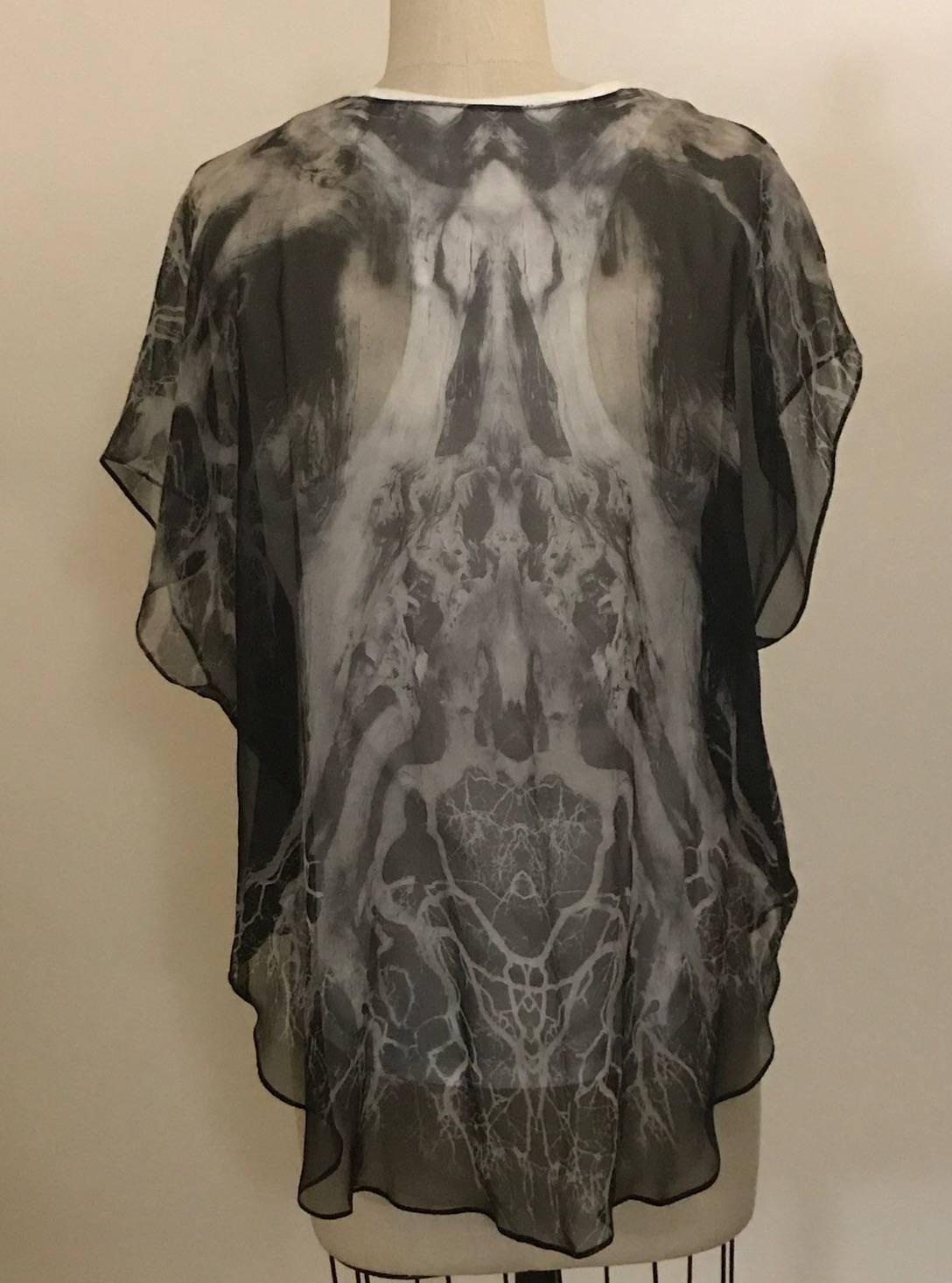 Alexander McQueen 2010 white racerback tank with attached sheer grey silk overlay featuring a print that seems to be a hybrid of lightning and roots.

Outer: 100% silk.
Inner: 100% cotton.

Made in Italy.

Size IT 42, approximate US 6.