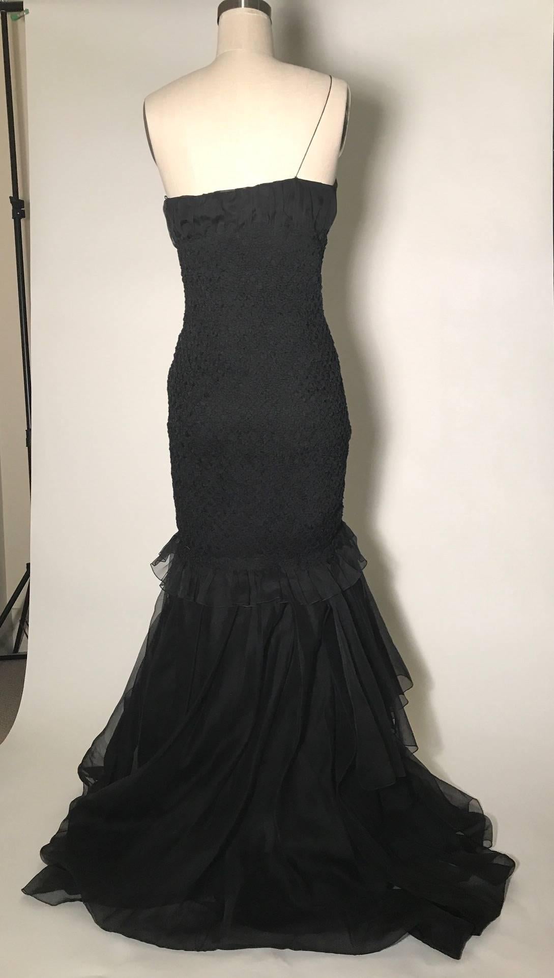 Prada one shouldered gown with stretchy textured detail and bodice. Rosette detail at shoulder with a spaghetti strap. Rosette detail at tiered draped hem. Side zip and hook and eye.

100% silk. 

Made in Italy.

Size IT 40, approximate US 4, see