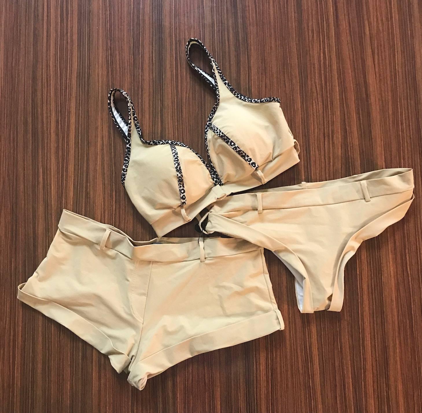 Alexander McQueen three piece bikini produced as Spring/Summer 2005 production sample. Very rare, may have never made it into actual production!
 
One top and two bottoms (one standard bikini, one boy short.) Top features leopard print trim, belt