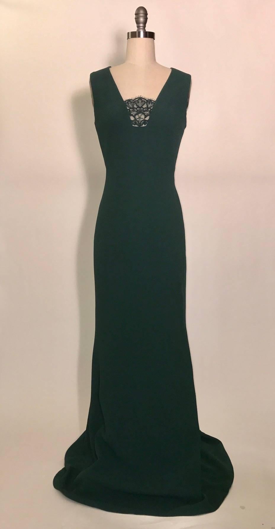Alexander McQueen 2012 deep forest green dress in a slightly crinkle textured silk crepe with lace insert at bust. Very slight train (back is about 5" longer than front.) Sleeveless, back zip and hook and eye. 
  
Fabric 1: 100% silk. 
Fabric