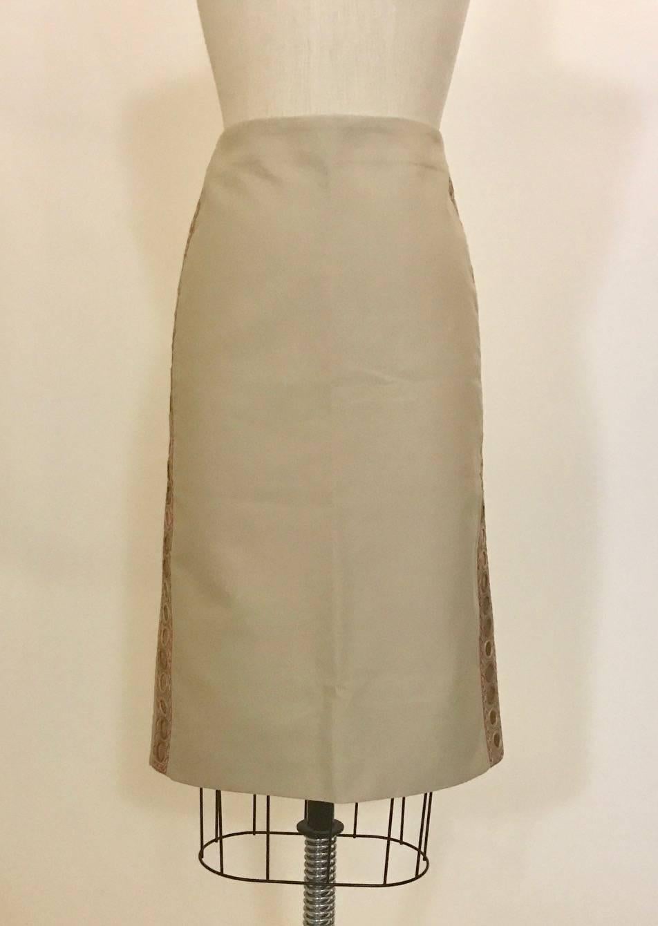 Alexander McQueen embroidered sand colored pencil skirt from his 2004 collection. Embellished with circular distressed mirrors run up each side, inset on a light olive ribbon with pink embroidery. Slit at back center, back zip and hook and eye.