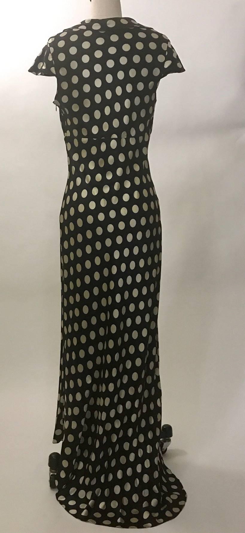 Moschino Couture! 1980's black and off-white polka dot dress with slight train at back. Collar at v-neck. Zipper and hook and eye at side. 

No content tag, based on another Moschino garment we have in the same fabric, we think it's 100% silk.