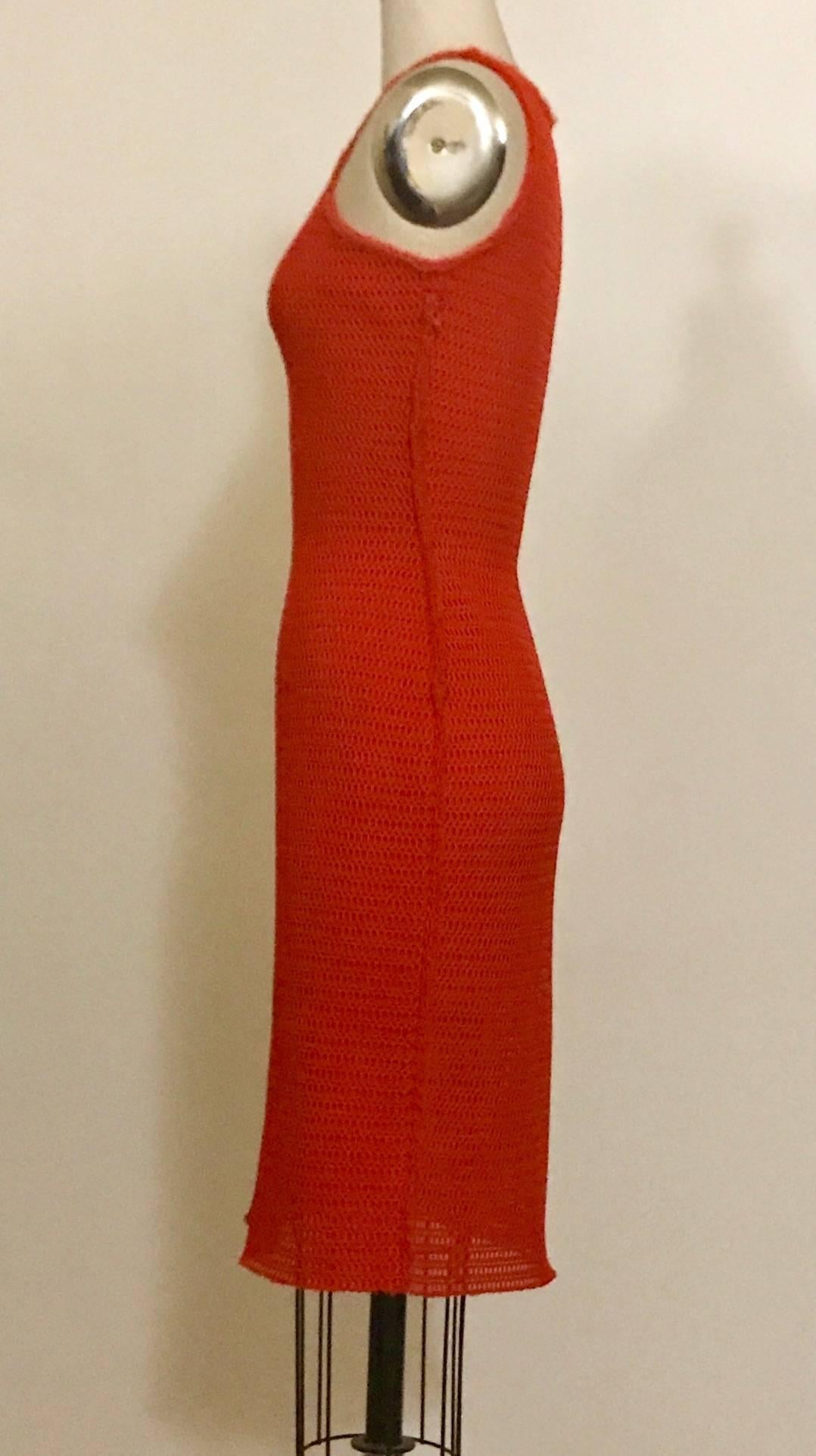 Lanvin red knit mesh body con dress features two overlapping layers of mesh. Very slightly sheer (tiny peekaboos where the mesh holes overlap.) Raw edged chiffon-like trim around neck, arm holes, and at side seams. Side zip.

100% polyamide. 

Made