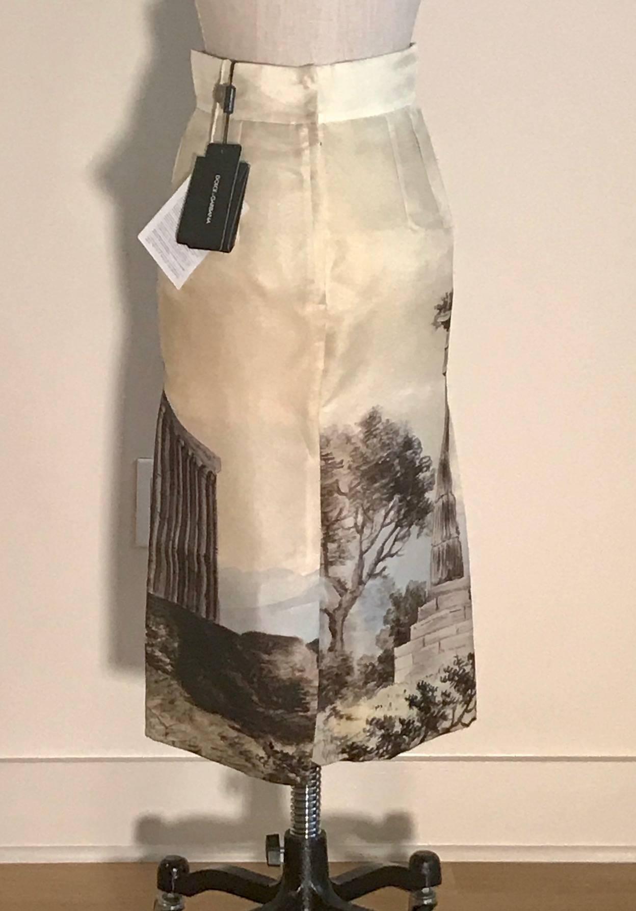 Dolce 
Gabbana cream silk pencil skirt featuring a watercolor like temple print. From the Spring/Summer 2014 collection. Back zip and snaps, slit at center back.

100% silk, fully lined. 

Made in Italy.

Size IT 38, approximate US 2. See