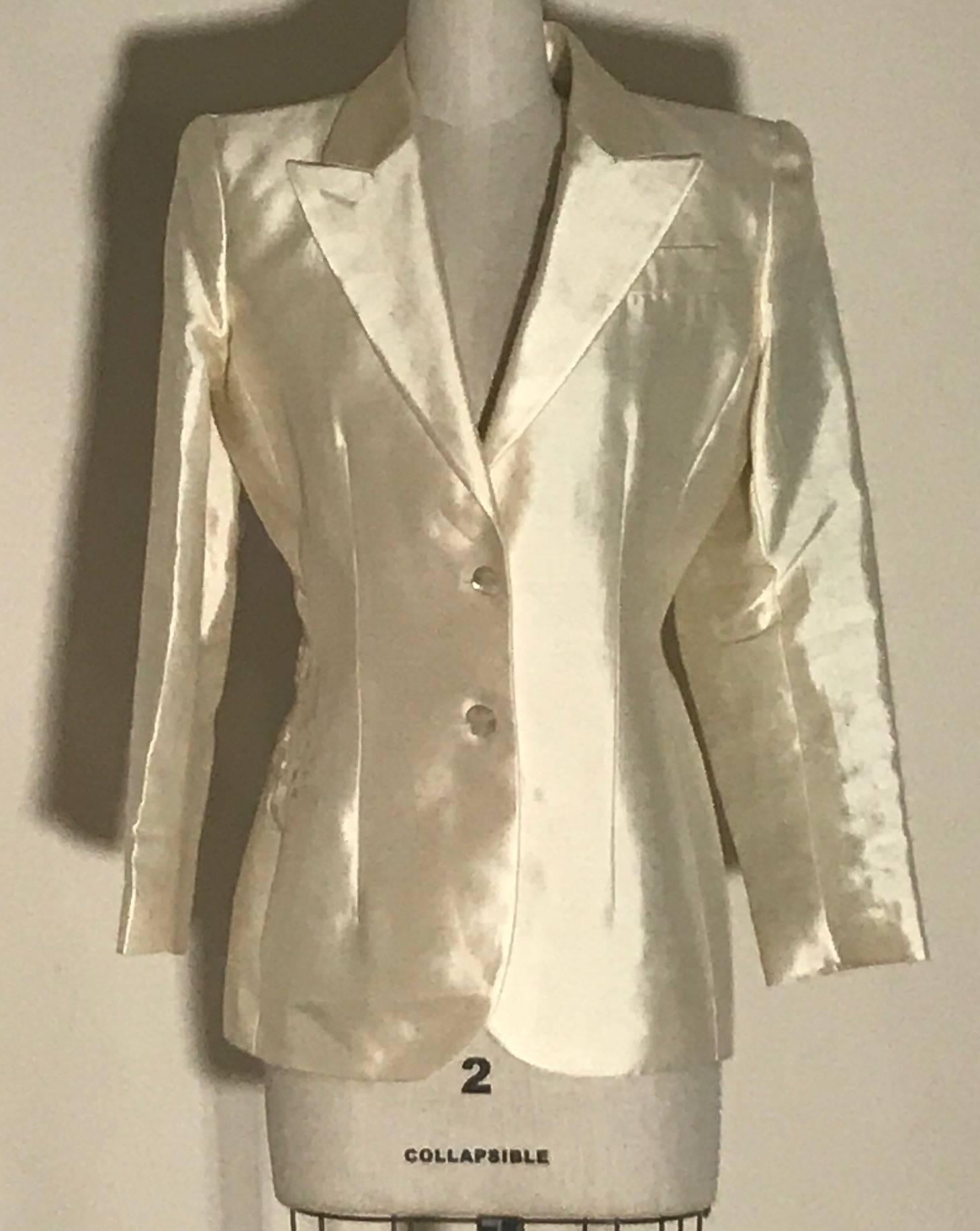 Alexander McQueen cream silk jacket with cut out leaf pattern lace detail at back from his Spring 1999 collection, "No. 13."  Leaf embroidery wraps around edge of lace to side front at one side. Light padding at shoulders for shape. Two