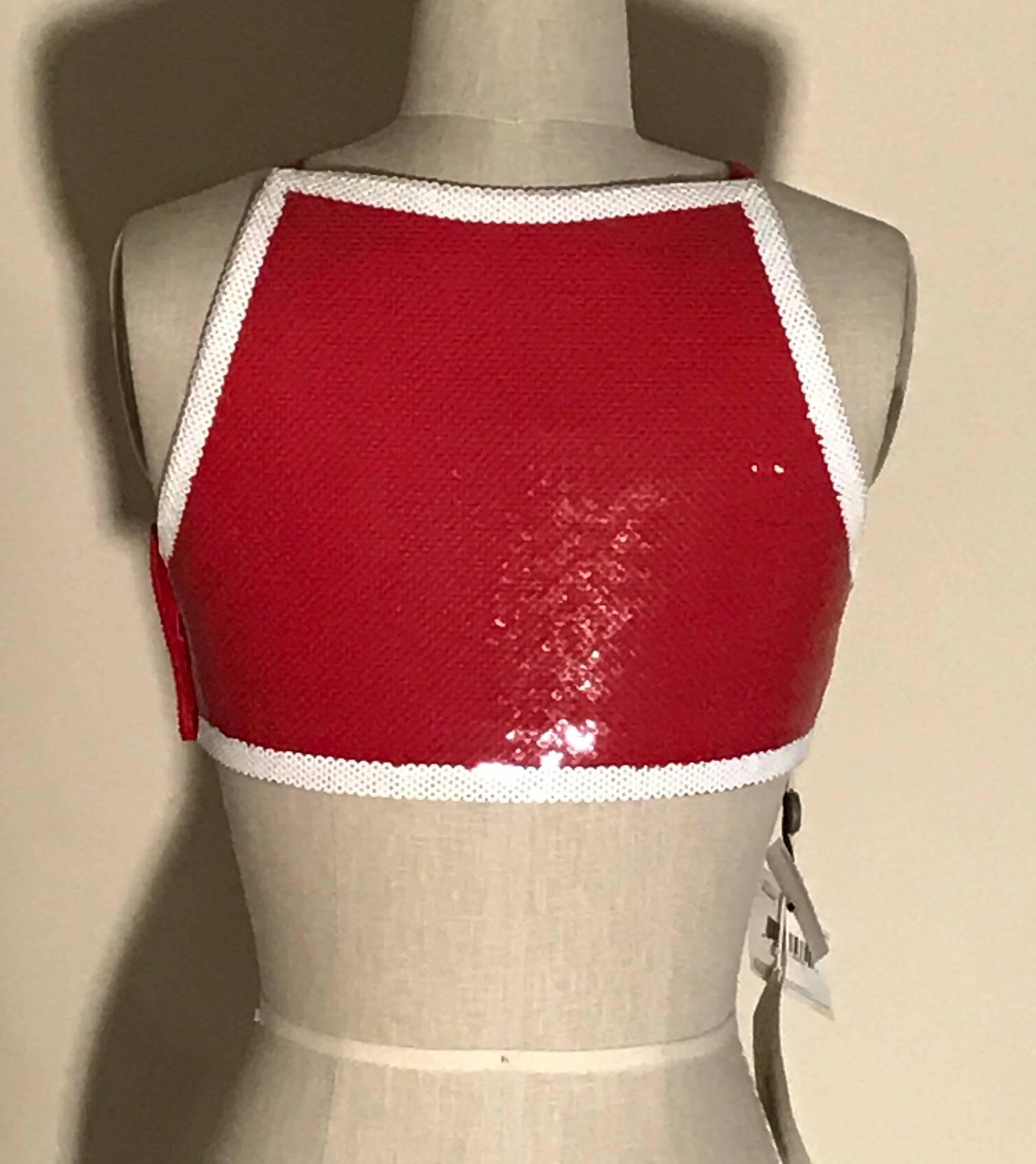 Moschino Couture by Jeremy Scott red sequin SHOP sign crop top. Side zip, interior buttons at straps. Perfect with jeans or a high waisted white pencil skirt. 

97% rayon, 3% other.
Fully lined in 85% rayon, 15% elastane.

Made in Italy.

Labelled