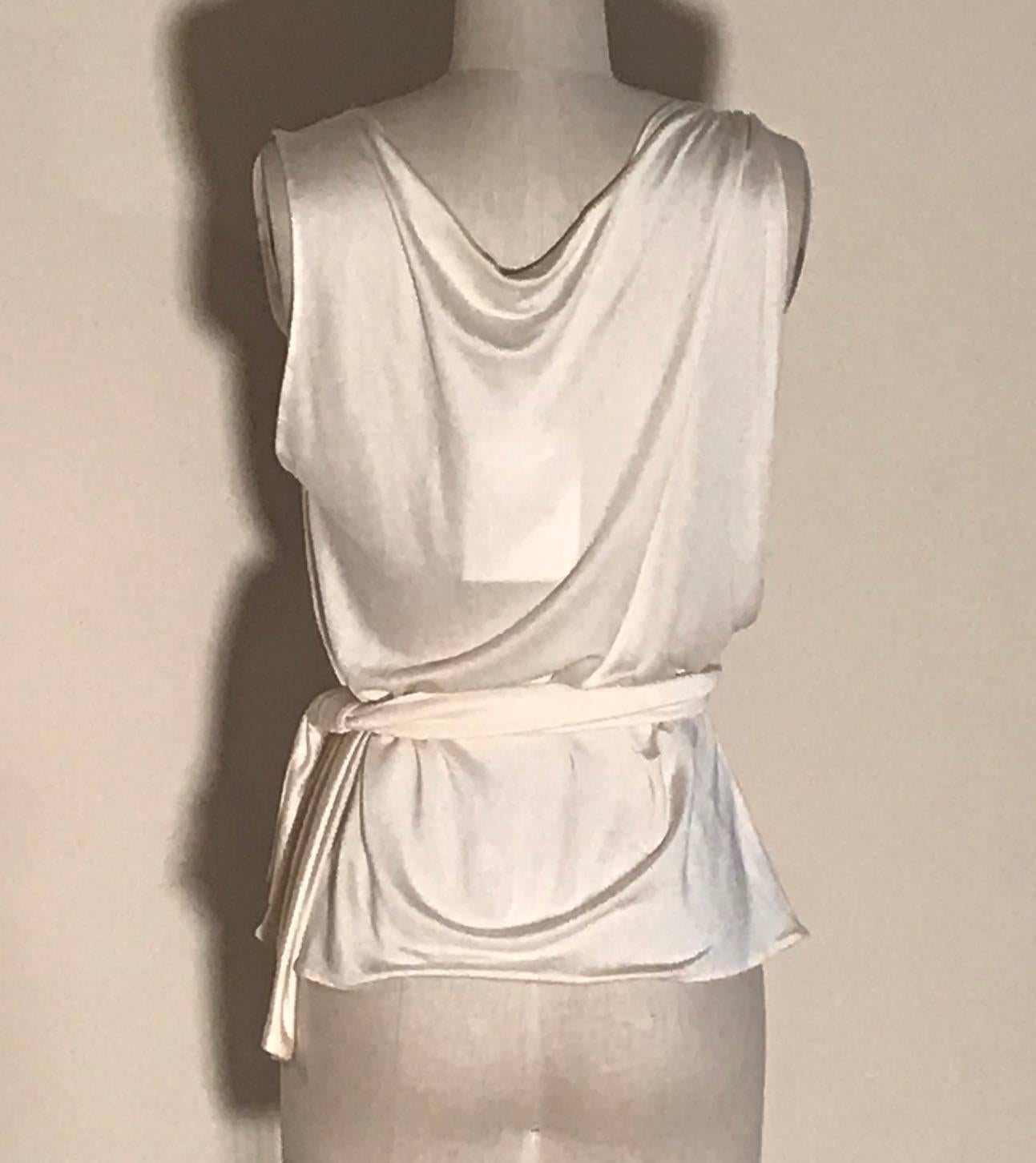 Christian Dior Boutique cream silk jersey cowl neck tank with attached grey Dior logo print panel that drapes across and is held in place with two strips of fabric attached at side forming a belt. Arm hole on the side with panel dips down to where