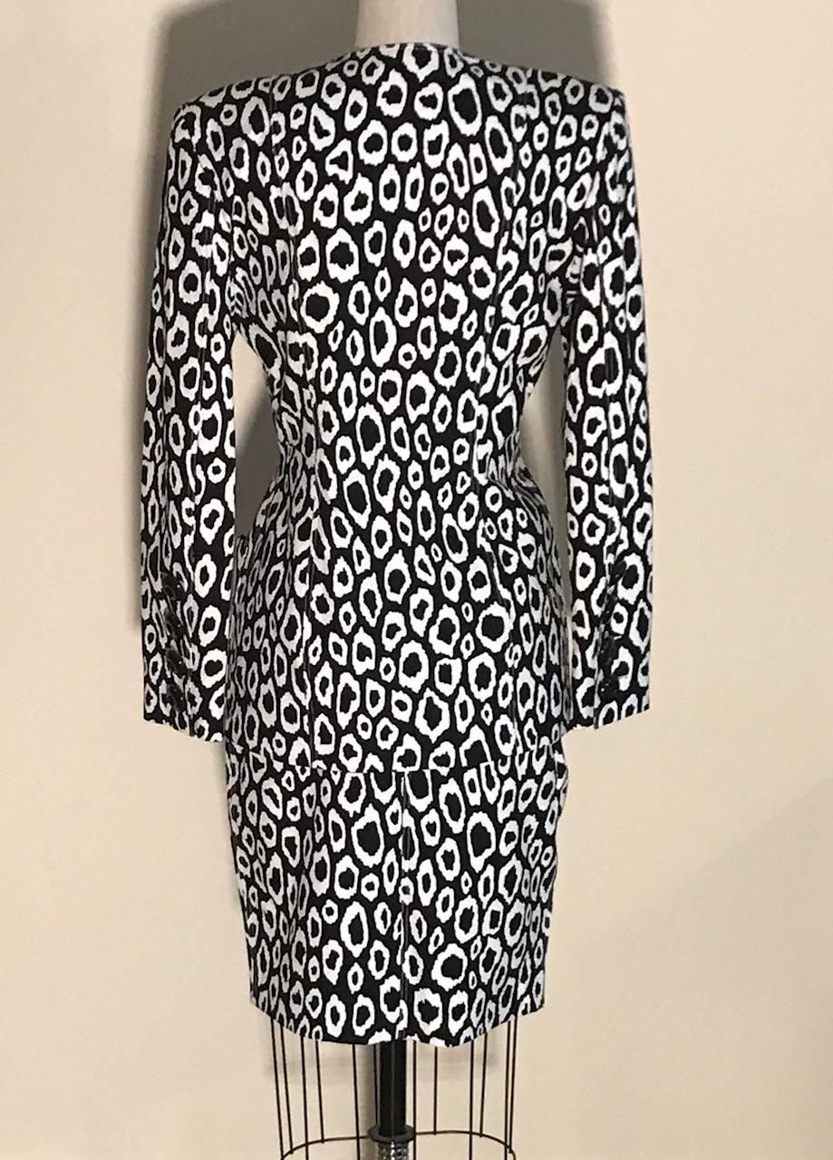 Patrick Kelly 1980s vintage black and white animal print skirt suit. Pockets at skirt and patch pockets at jacket. Medium weight padding at shoulders. Skirt fastens with zip and button at back, jacket fastens with large black plastic buttons at