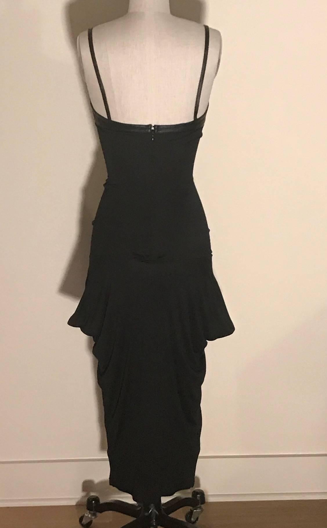 Alexander McQueen black super soft jersey midi length dress with leather detailing at bust. Sculptural draping at sides just below hip. Back zip and hook and eye. 

80% viscose, 20% silk, with leather detail.

Size IT 40, approximate US 2/4. See