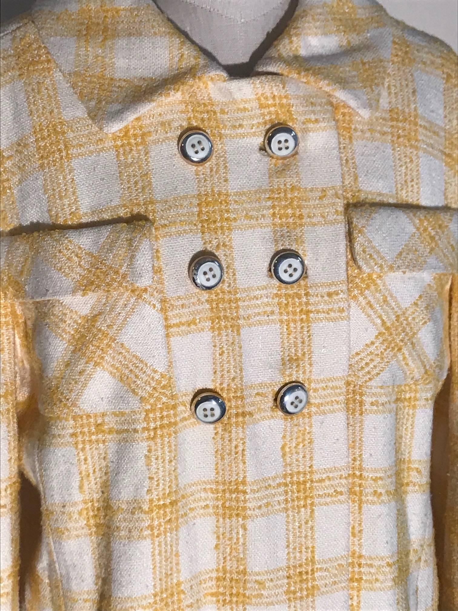 Vintage 1960s Riva for Miss Magnin by I Magnin yellow and white plaid coat. Patch pockets and six white buttons at front with silver trim.  (Three decorative, three working with extra interior snaps to fasten.) Pockets hidden in seams at front