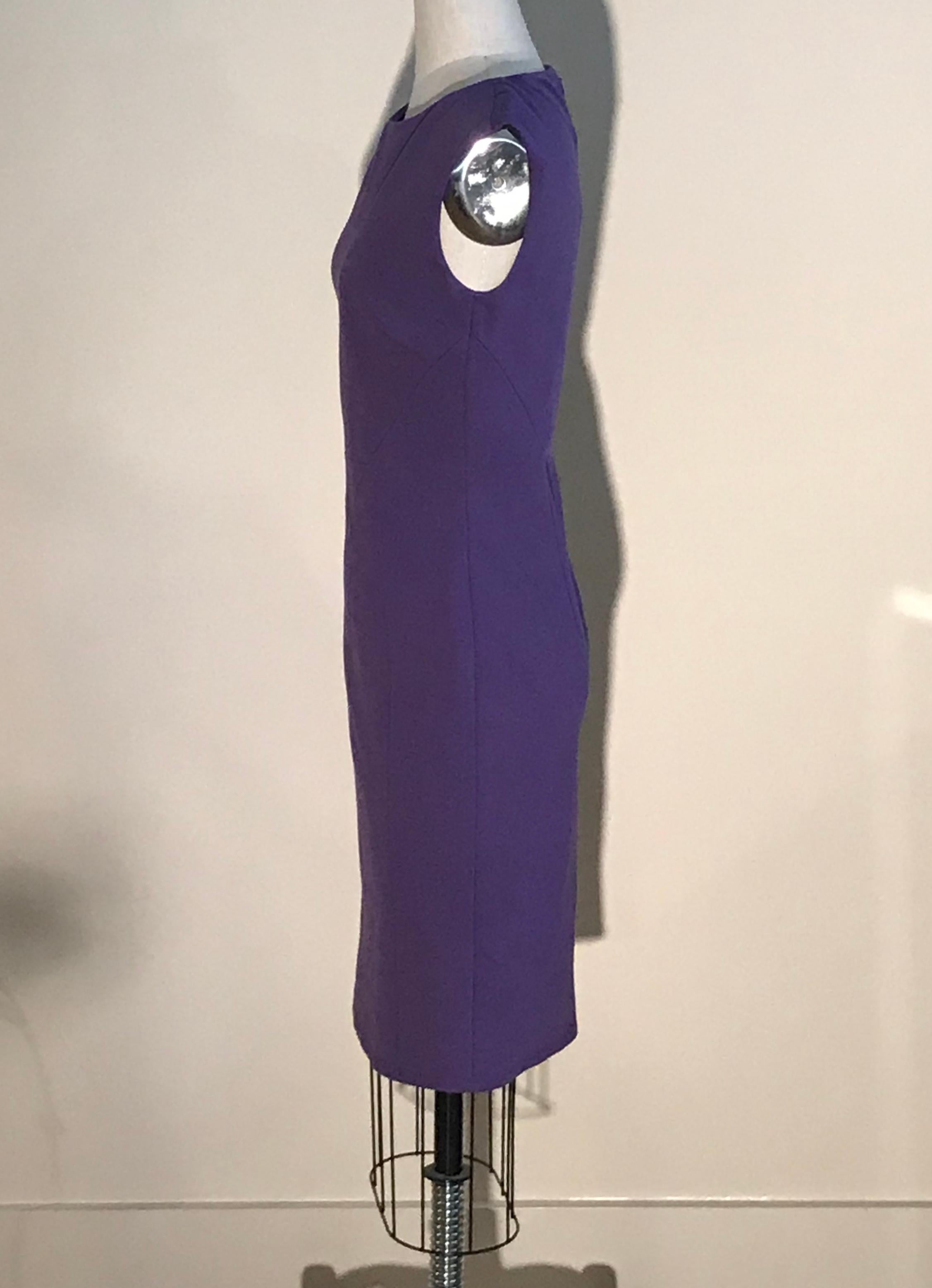 Emilio Pucci Purple stretch knit dress with boat neck and H shaped panel detail at front. Back zip and hook and eye. Branded 'Pucci' at zipper.

Please note that color is somewhat lighter/less blue than photos appear- we had a hard time capturing