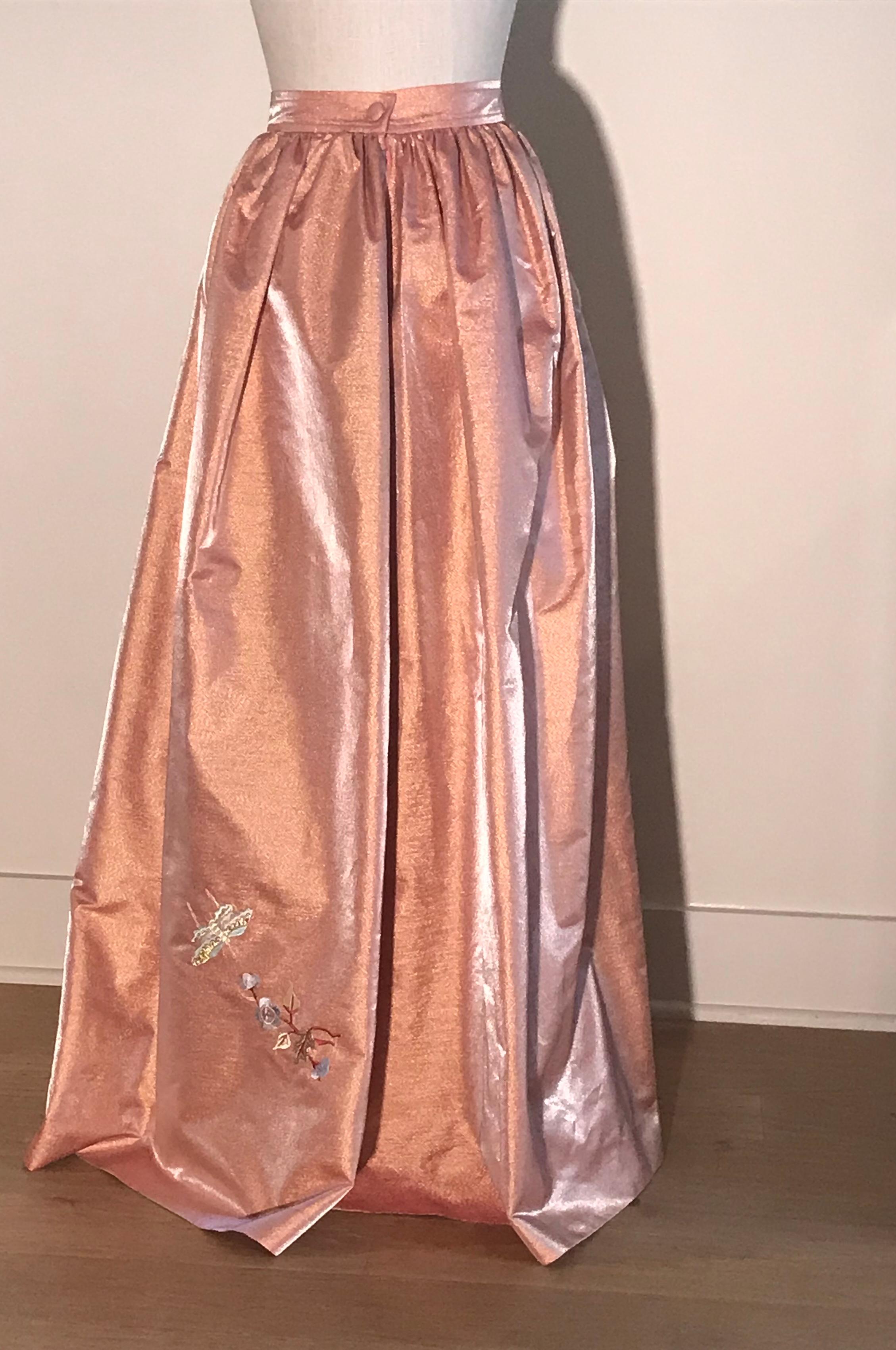 Christian Lacroix vintage embroidered full length skirt in salmon pink with a light metallic sheen. Bird, butterfly and floral motif at side front and a couple flowers at back. Side zip and cloth covered button. 

42% polyester, 31% metallic, 27%
