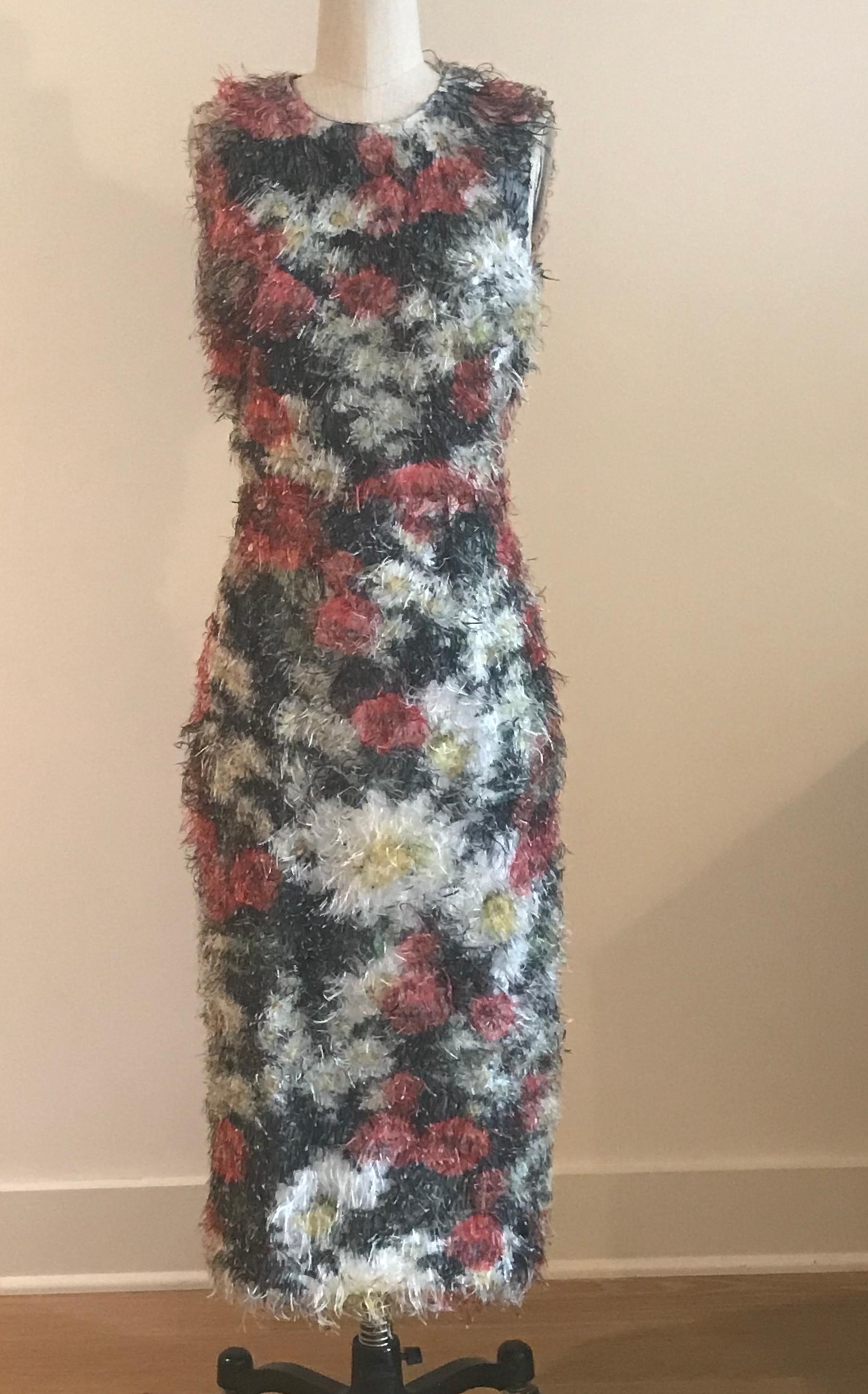 Amazing fuzzy statement dress from Dolce & Gabbana features red, yellow, white and green floral print covered all over in wild eyelash fringe. Floral lining. Back zip and hook and thread loop closure.

100% polyester.
Fully lined in 96% silk, 4%