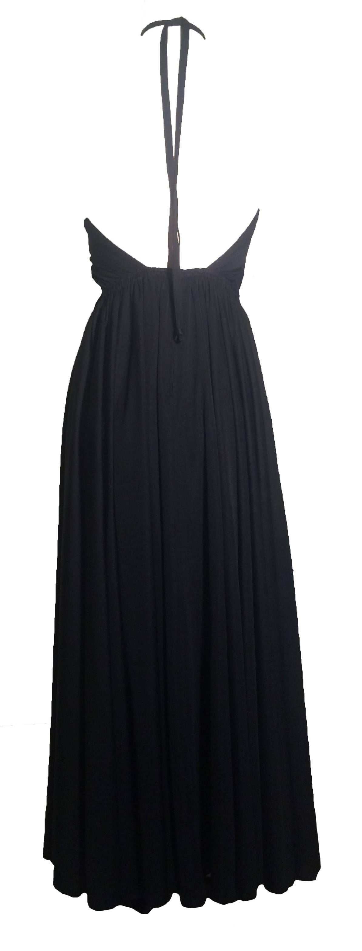 Surprisingly risque for an Adele Simpson, this black backless 70's jersey knit halter dress with a peekaboo keyhole looks amazingly modern!

Halter straps create ruching at chest. Drawstring at waist.

Back zip and hook and eye.

Dress was purchased