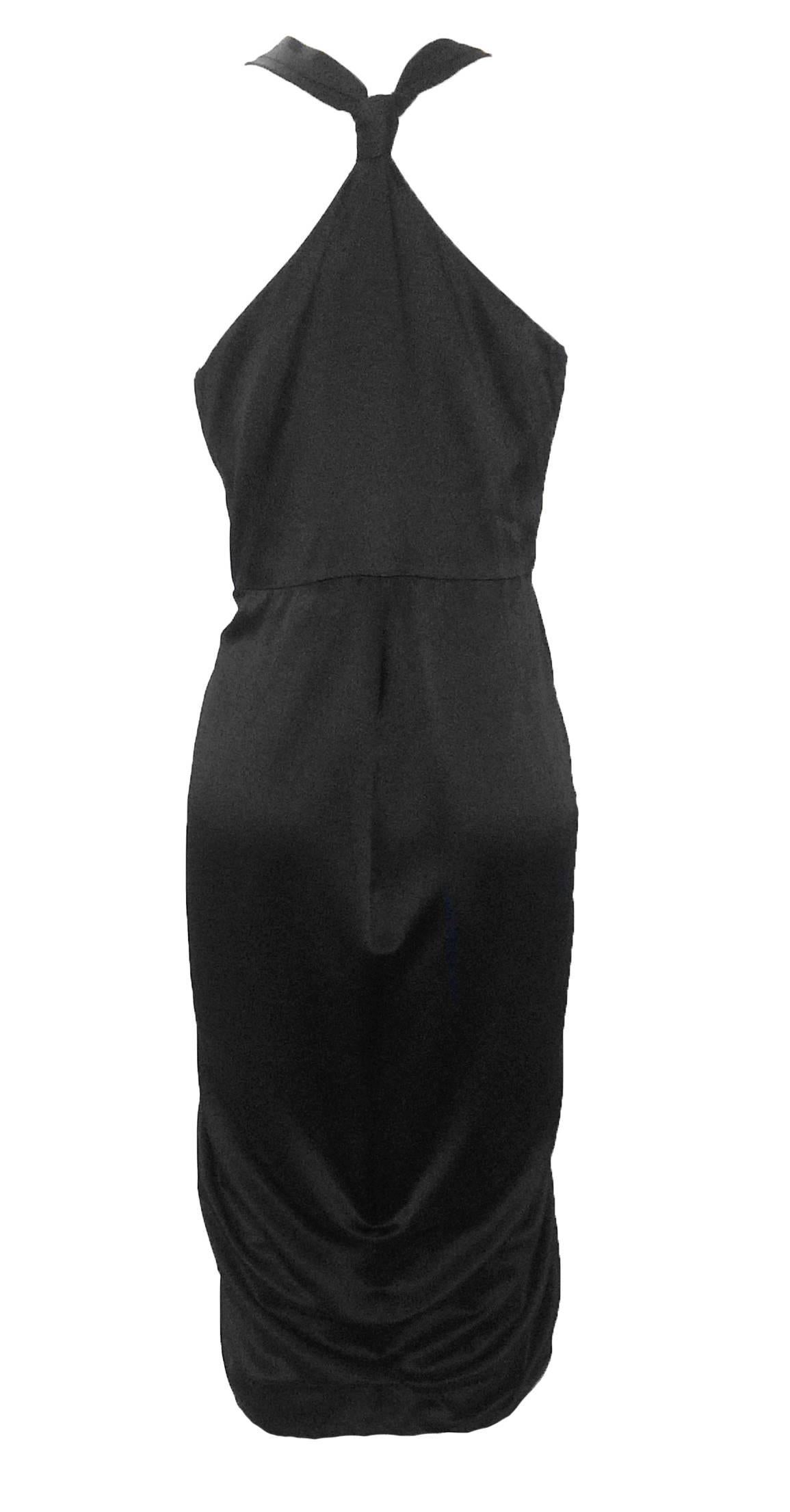 Alexander McQueen black silk cocktail dress from 2010. Pleated detail adorns the top, while dress falls in a wrap style at the bottom. Knotted racerback.

100% silk. 
Fully lined in 74% acetate, 26% silk.

Made in Italy.

Size IT 42, approx US 6.