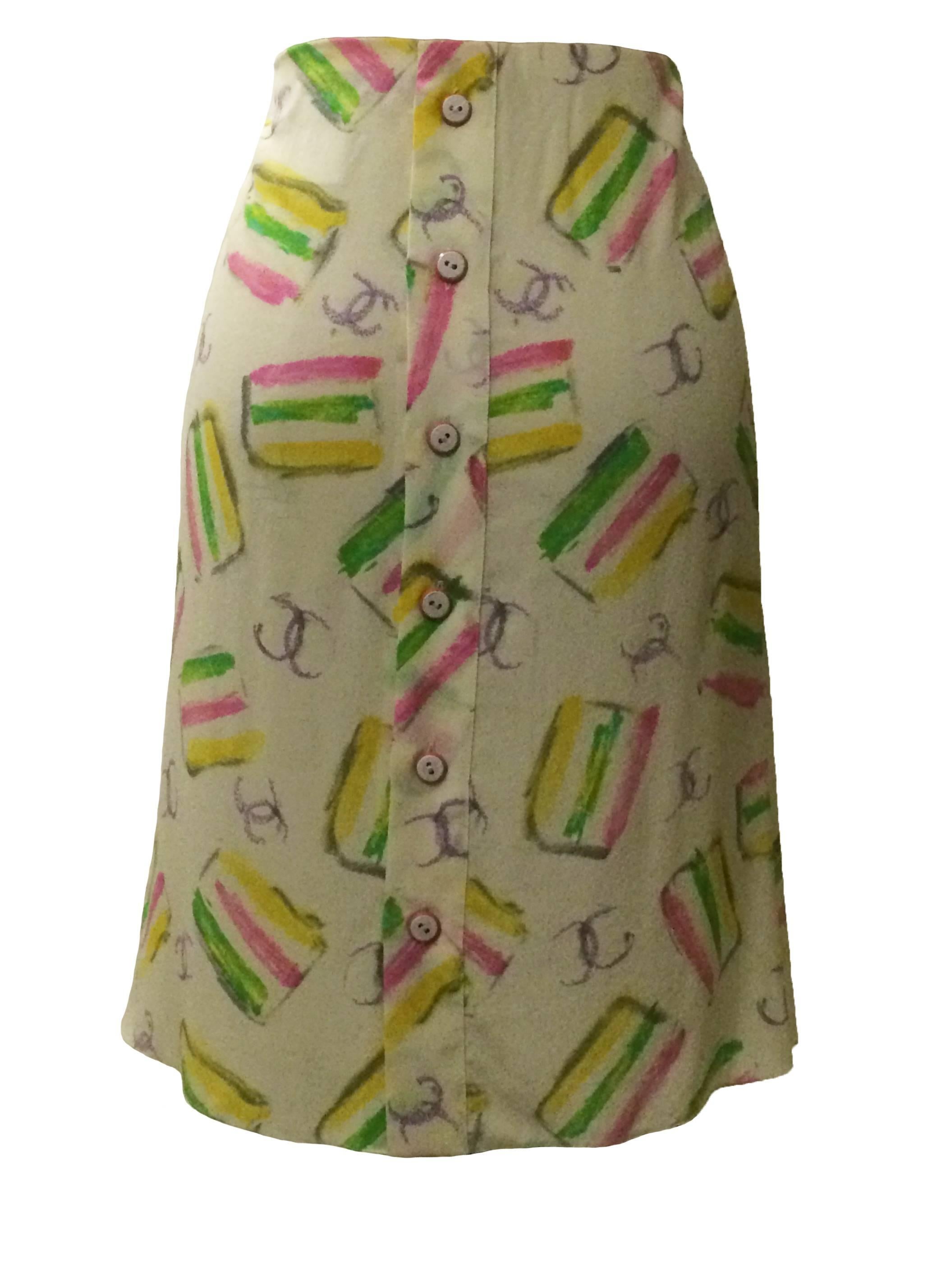 Chanel silk skirt in colorful print from the 2004 cruise collection. Draped ruffle at front. Buttons up back. Buttons read 'Chanel, Paris.'

100% silk.

Made in France.

FR 40, approximate US 8/10.
Waist 32