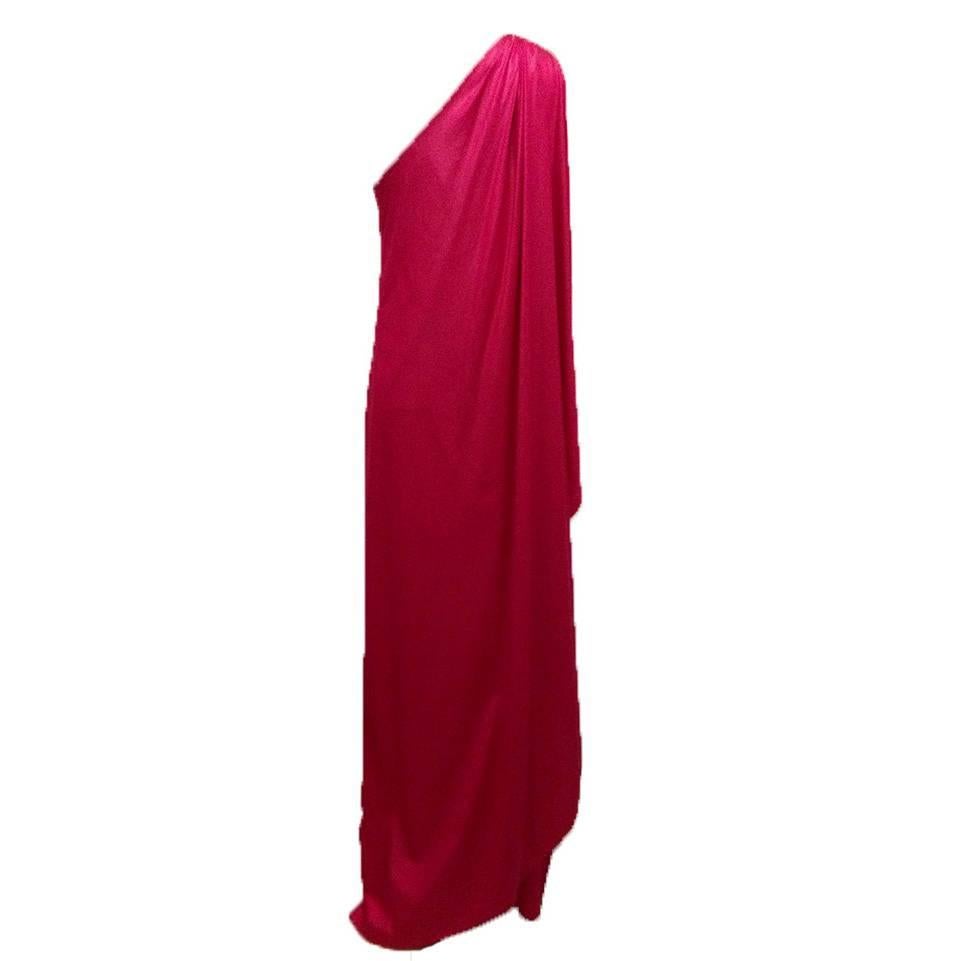 Red one shoulder toga-style gown from the 1970s Halston & Formfit Rogers collaboration.

Halston vintage raspberry jersey dress in asymmetrical one-shoulder cut. All edges are hand rolled/stitched. Pull over construction (no snaps or zips.)
